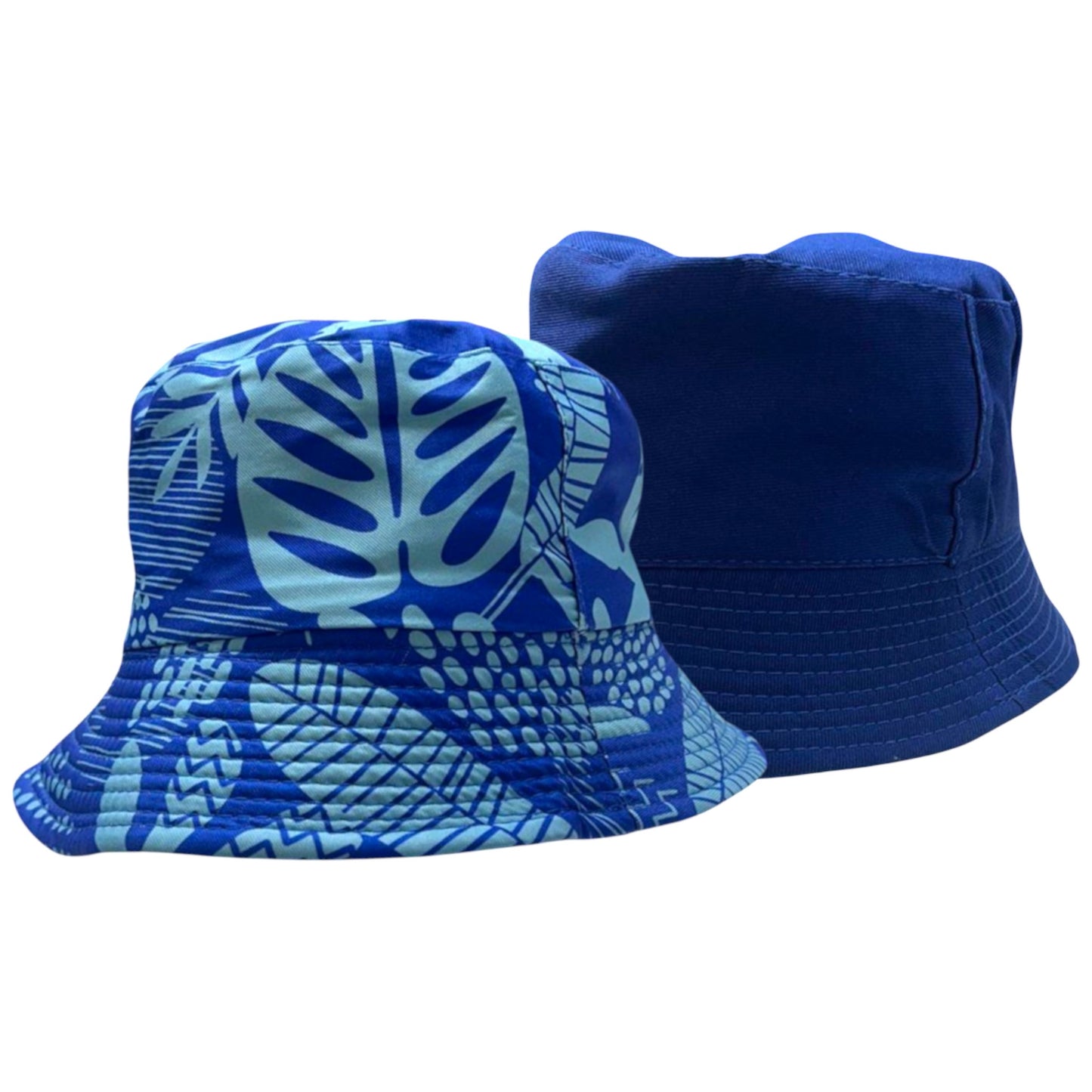 Kids reversible bucket hat with blue tropical leaf print on one side and solid navy blue on the other, lightweight cotton sun hat for boys and girls.