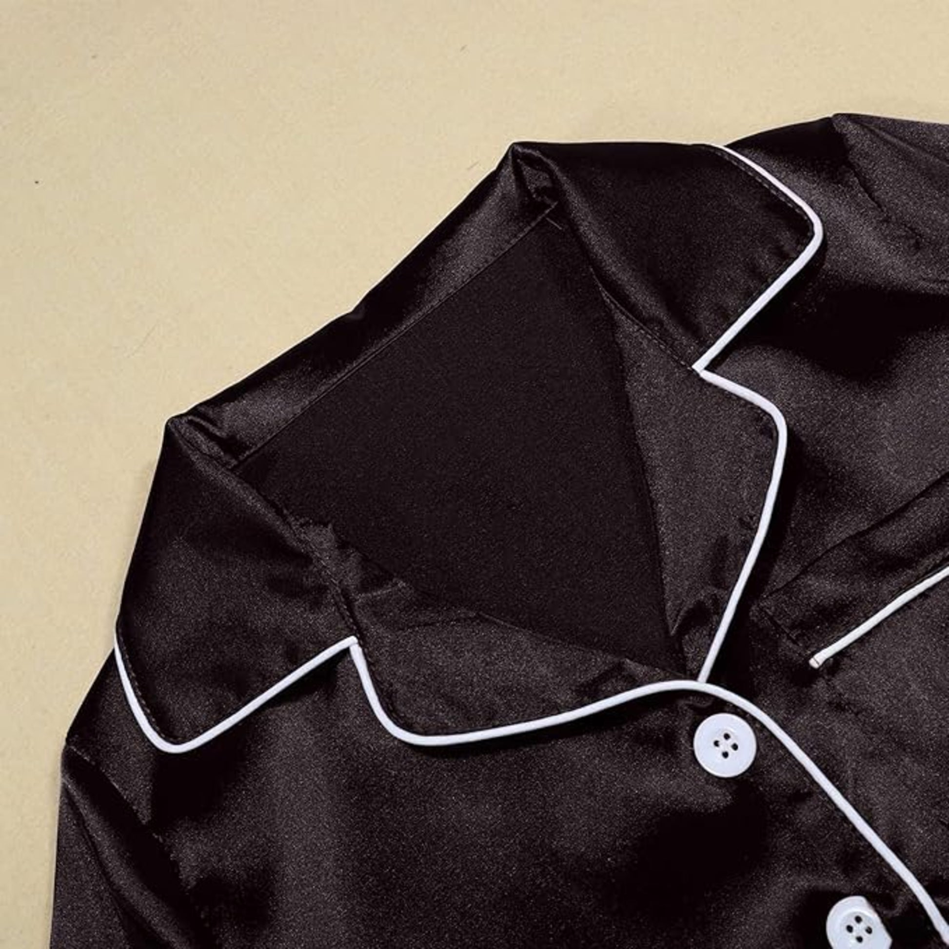 Women's soft silky touch satin pyjama set in Black with black piping, long sleeve button-up top and matching full-length trousers, comfortable nightwear