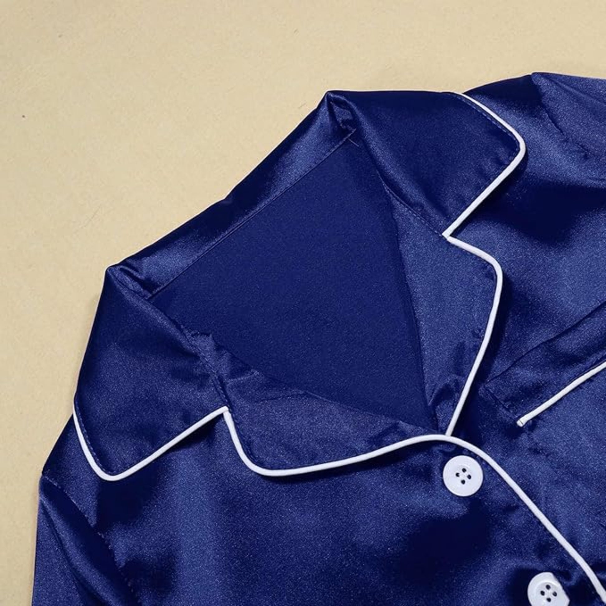 Women's soft silky touch satin pyjama set in navy with black piping, long sleeve button-up top and matching full-length trousers, comfortable nightwear