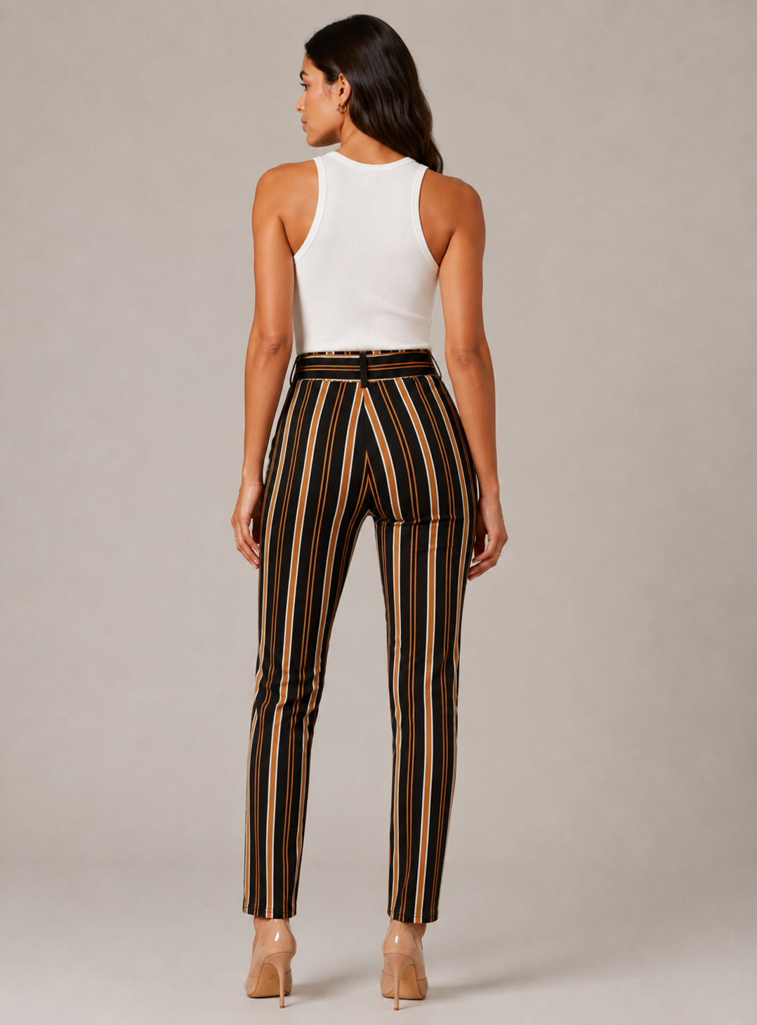 Women's high-waisted belted trousers in black with vertical tan, white, and orange stripes, featuring a tie-front waist and slim fit.