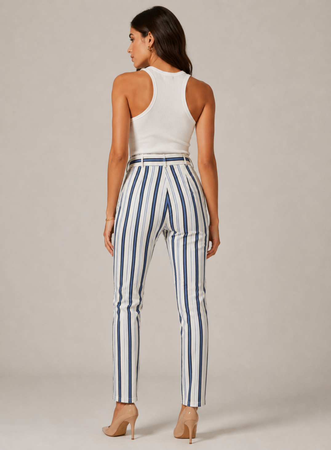 Women's high-waisted belted trousers in white with vertical navy stripes, featuring a tie-front waist and slim fit.