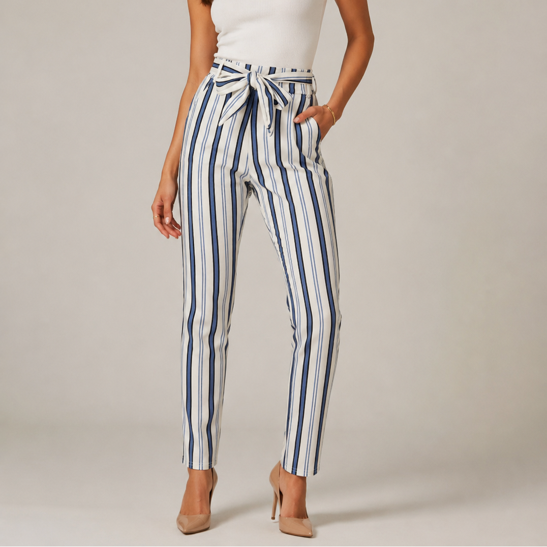 Women's high-waisted belted trousers in white with vertical navy stripes, featuring a tie-front waist and slim fit.