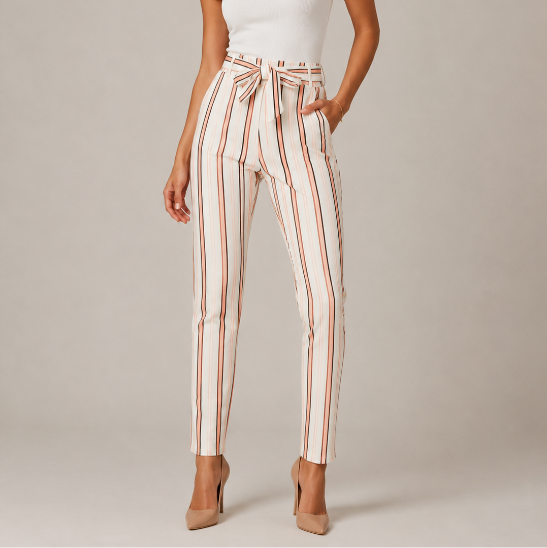 Women's high-waisted belted trousers in white with vertical black and pink stripes, featuring a tie-front waist and slim fit.