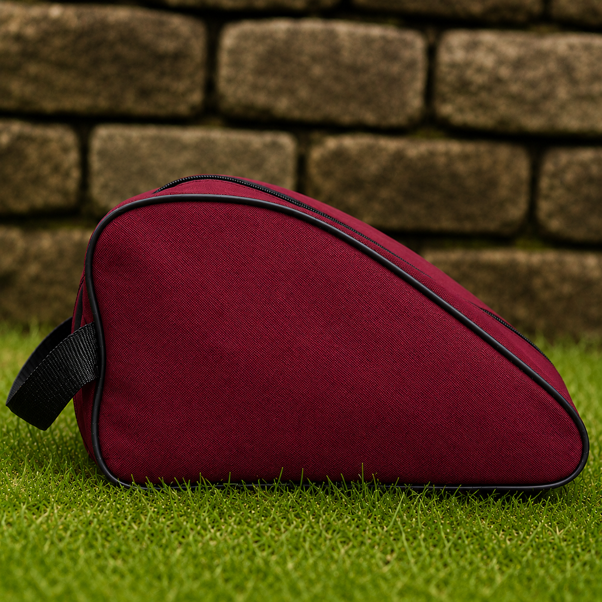Burgundy waterproof boot bag with a curved zip opening and durable fabric finish