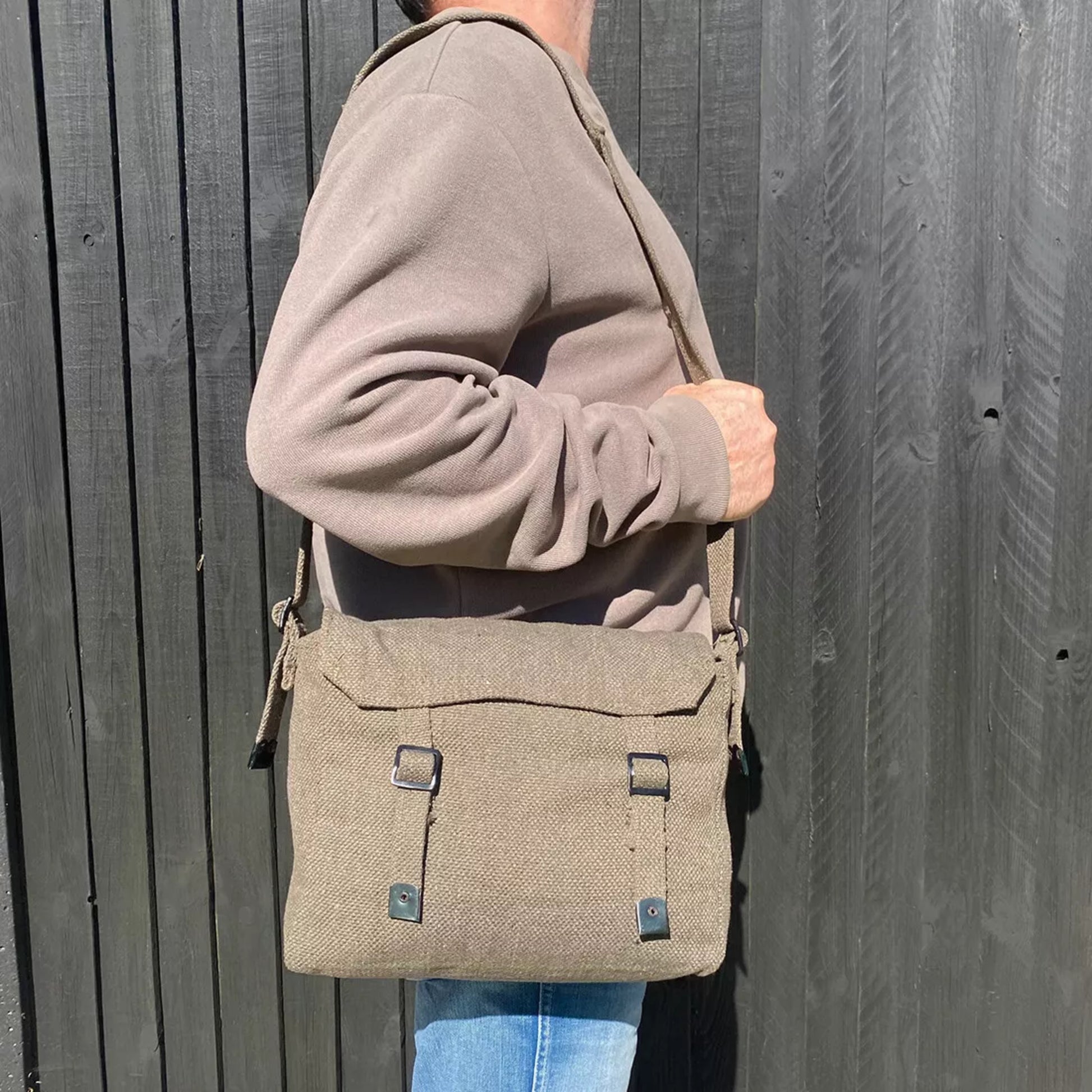 Canvas army military style shoulder bag with adjustable strap and buckle fastening in olive green