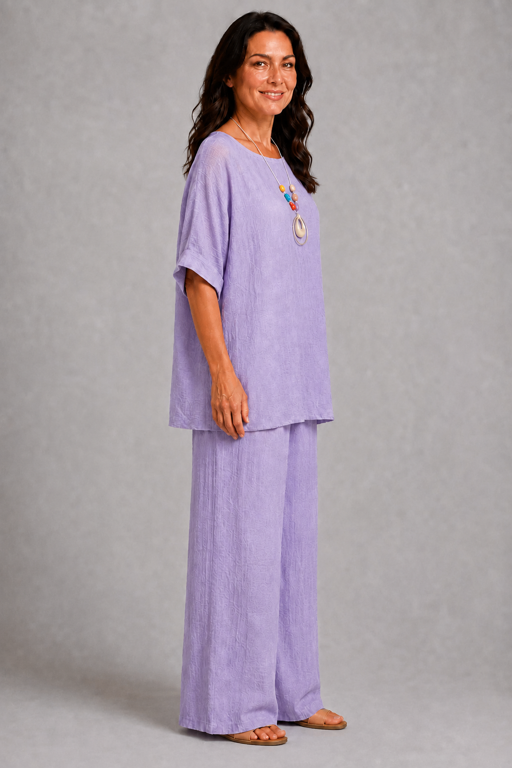 Lilac women’s co-ord set with a relaxed longline top, wide-leg trousers and coordinating statement pendant necklace.
