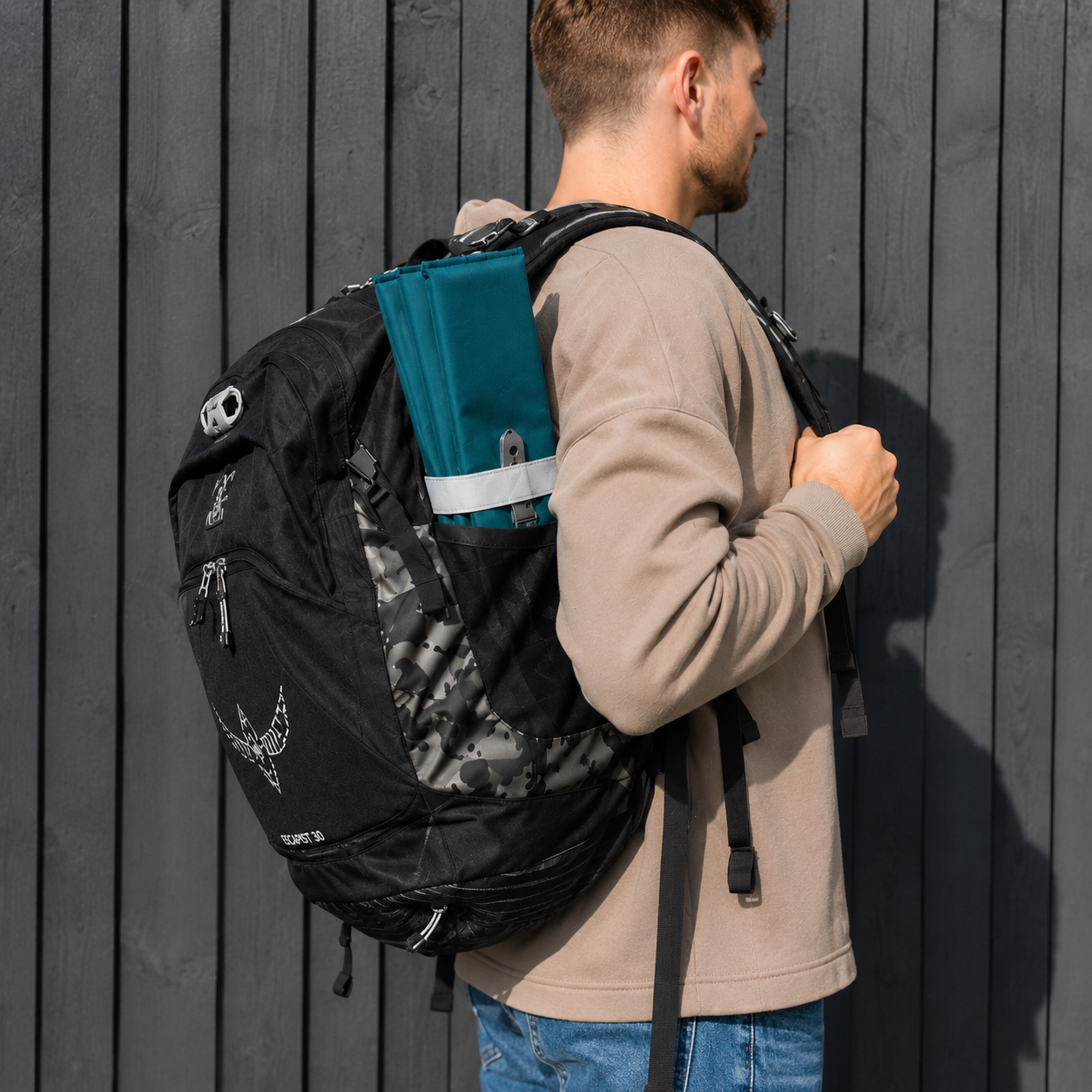 Teal Foldable waterproof camping sit mat with padded cushioning and an elastic carry strap for easy outdoor transport.