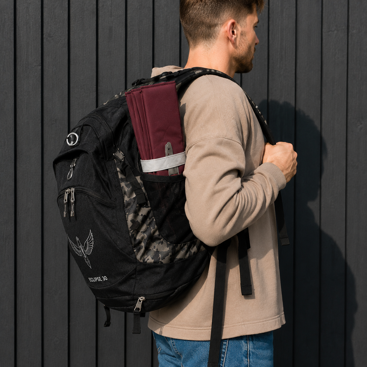 Burgundy Foldable waterproof camping sit mat with padded cushioning and an elastic carry strap for easy outdoor transport.