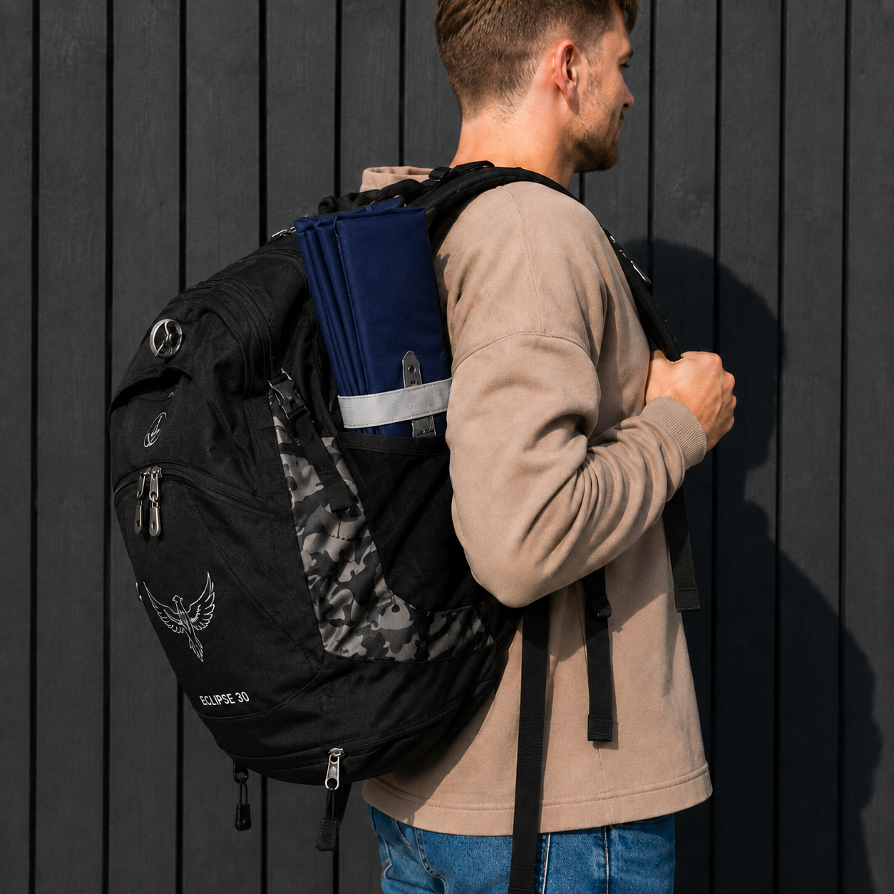 Navy Foldable waterproof camping sit mat with padded cushioning and an elastic carry strap for easy outdoor transport.