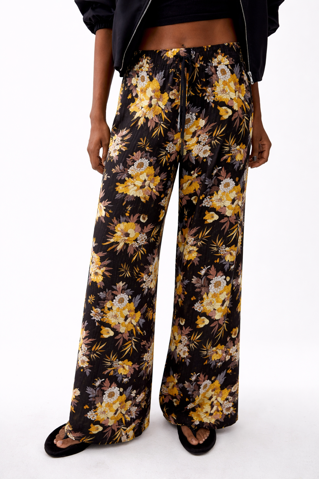Ladies floral palazzo trousers – lightweight wide leg summer pants with black background and yellow flower pattern