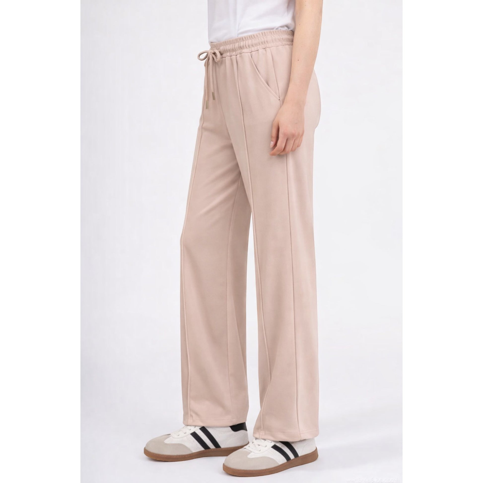 Upgrade your everyday wardrobe with these ultra-comfortable and effortlessly stylish wide leg trousers. Designed with a flattering high-rise elastic waistband and adjustable drawstring tie, these trousers combine comfort and elegance in one easy-to-wear piece.