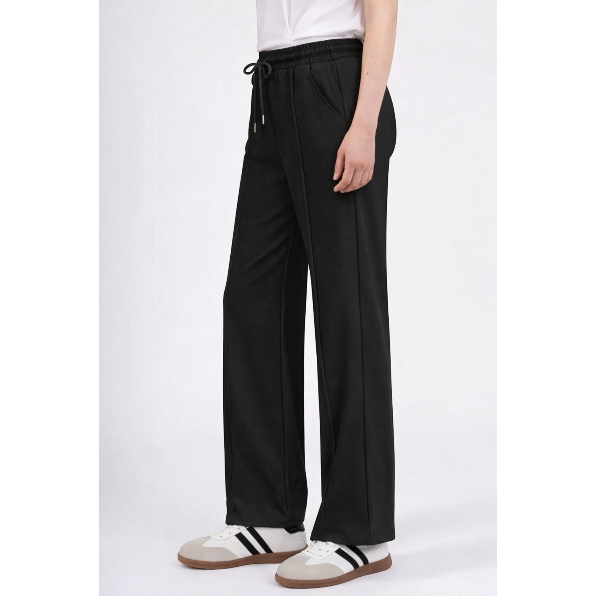 Upgrade your everyday wardrobe with these ultra-comfortable and effortlessly stylish wide leg trousers. Designed with a flattering high-rise elastic waistband and adjustable drawstring tie, these trousers combine comfort and elegance in one easy-to-wear piece.
