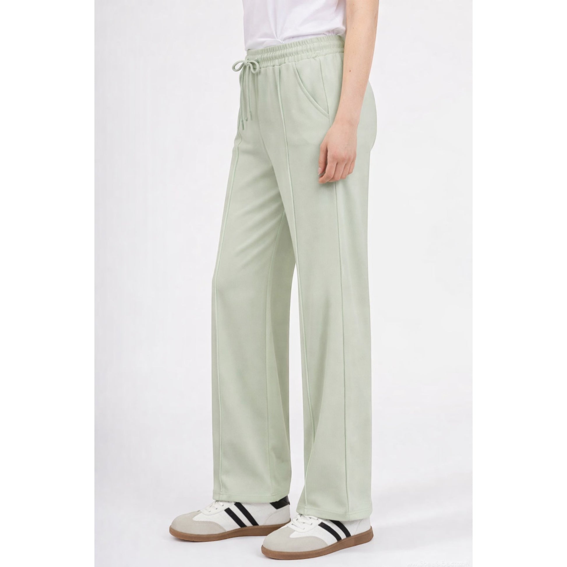 Upgrade your everyday wardrobe with these ultra-comfortable and effortlessly stylish wide leg trousers. Designed with a flattering high-rise elastic waistband and adjustable drawstring tie, these trousers combine comfort and elegance in one easy-to-wear piece.