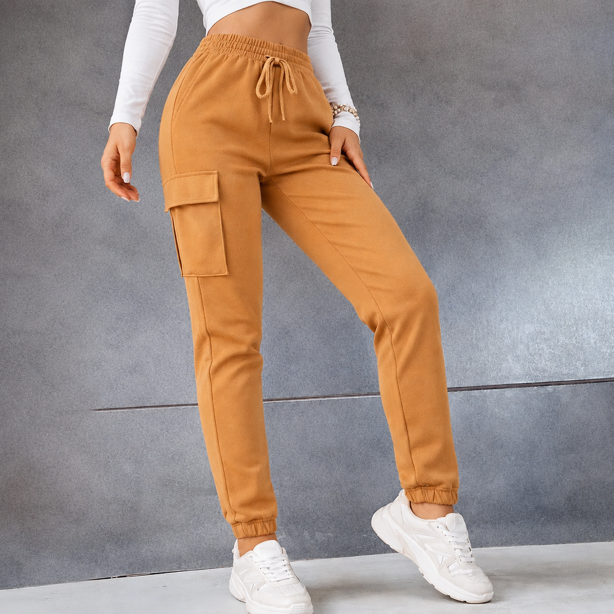 Women's camel combat-style joggers with elasticated waistband, drawstring tie, and side cargo pockets – casual utility trousers