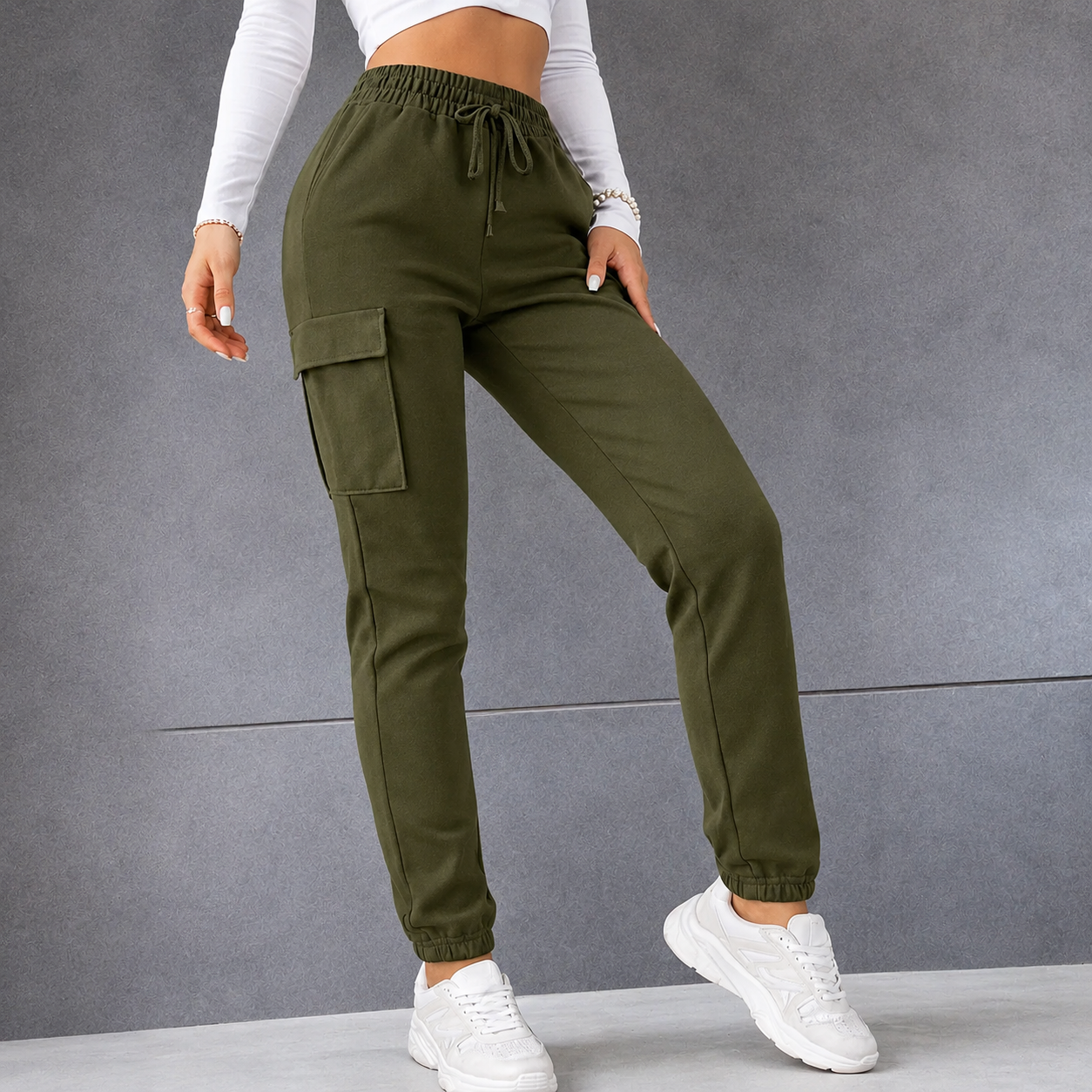 Women's khaki green combat-style joggers with elasticated waistband, drawstring tie, and side cargo pockets – casual utility trousers