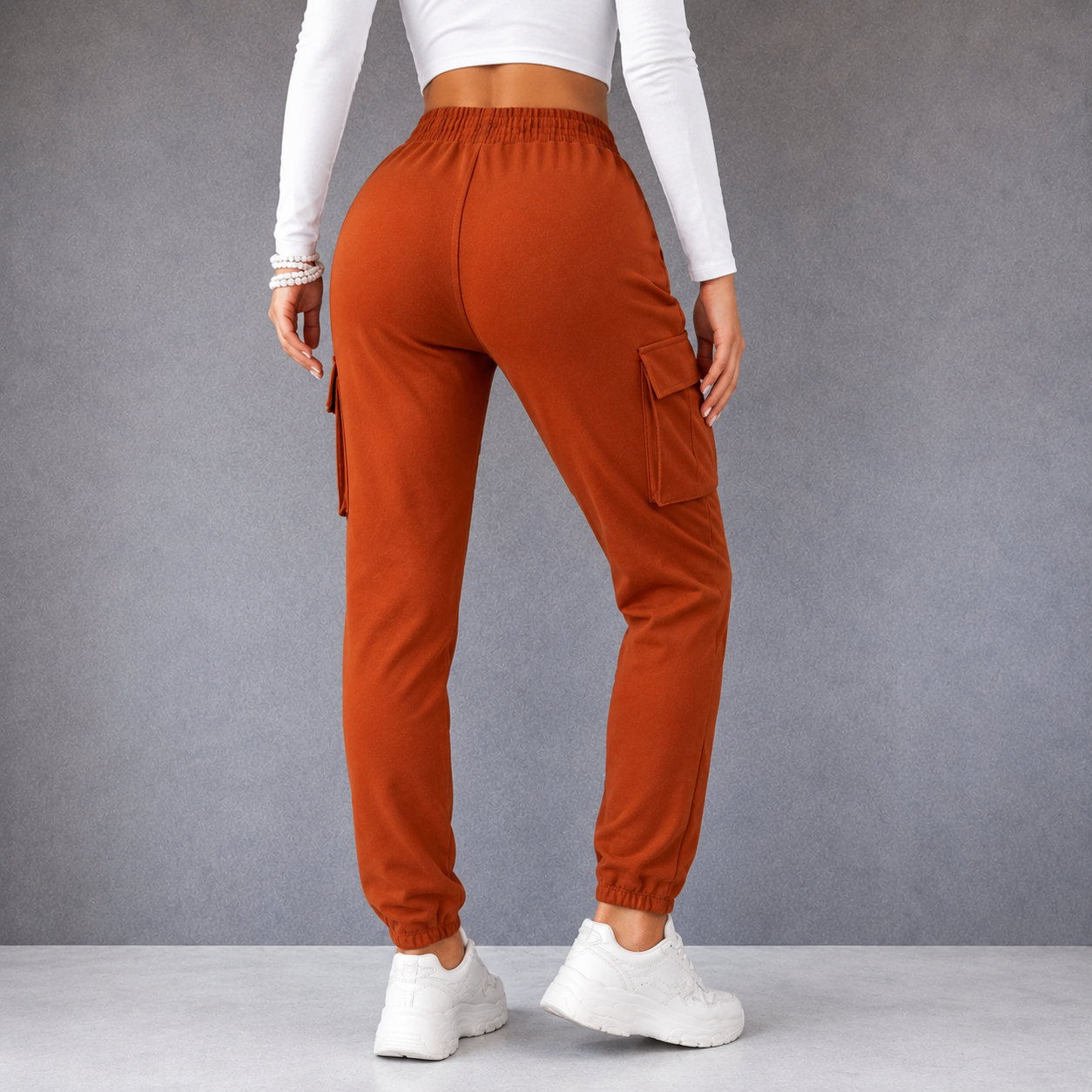 Women's terracotta combat-style joggers with elasticated waistband, drawstring tie, and side cargo pockets – casual utility trousers