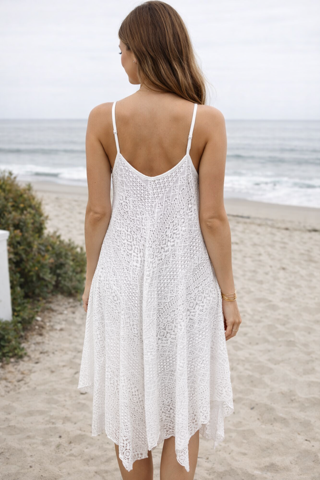 Elevate your warm-weather wardrobe with this asymmetrical lace slip dress, designed for effortless style and breathable comfort. Crafted from lightweight lace fabric, this V-neck lace sundress features a relaxed, flowy silhouette that drapes beautifully on the body. The delicate lace detailing and adjustable spaghetti straps create a flattering, feminine look perfect for any occasion.