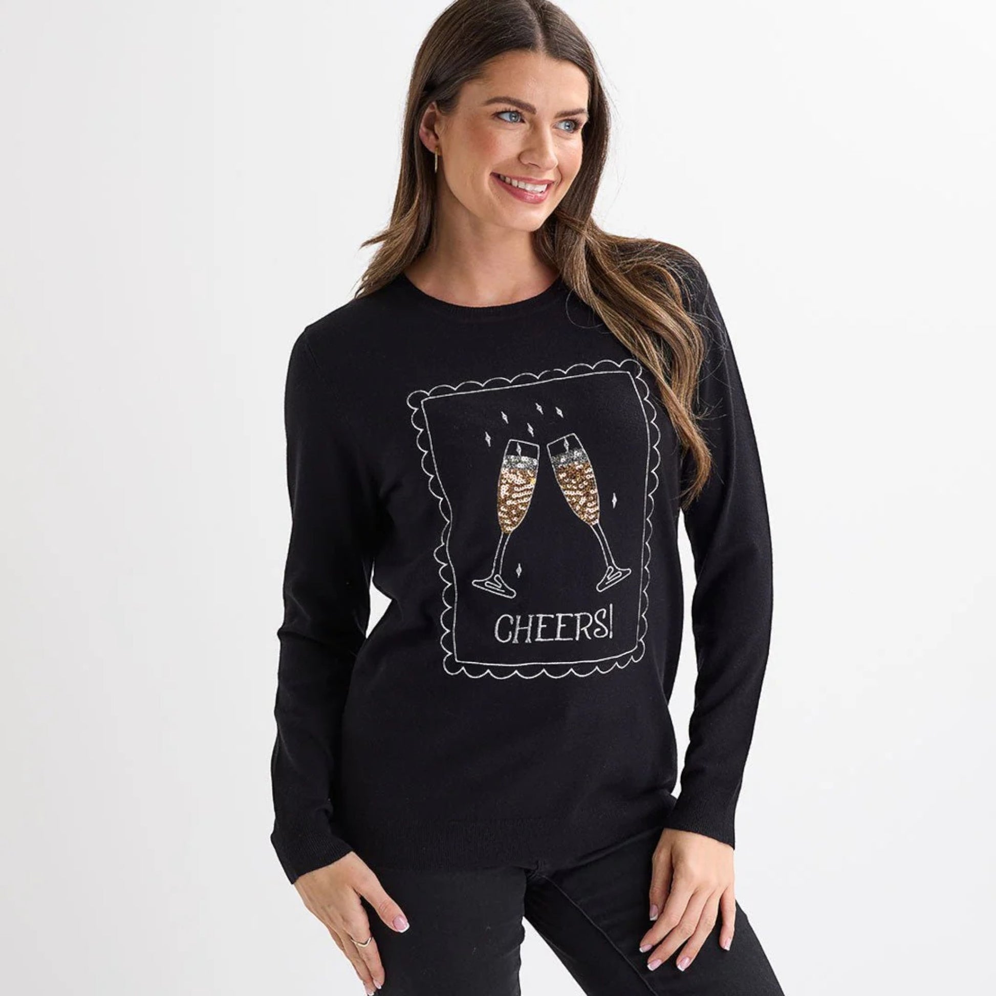 Ladies black christmas jumper with sequin champagne glasses and ‘Cheers!’ slogan, long sleeves and a festive xmas design.
