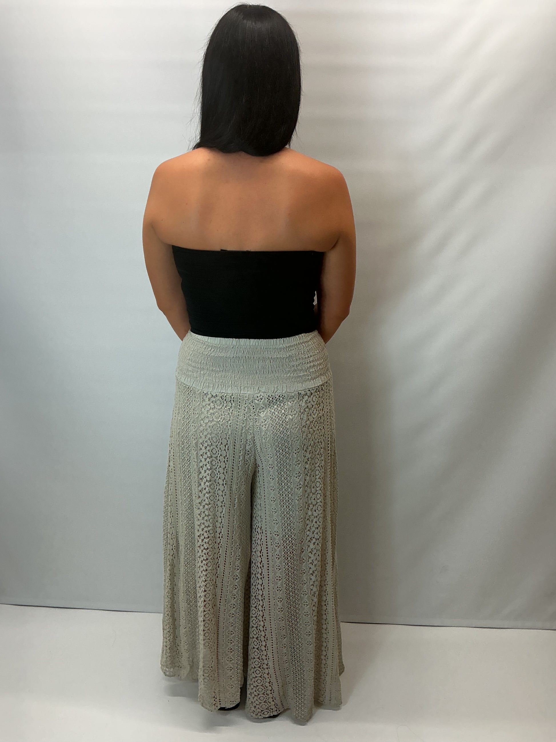 Upgrade your summer wardrobe with our lace wide leg trousers, designed for effortless style and all-day comfort. Featuring a high-waisted smocked waistband and a flowing wide-leg silhouette, these trousers create a flattering, elongating fit perfect for warm-weather dressing.