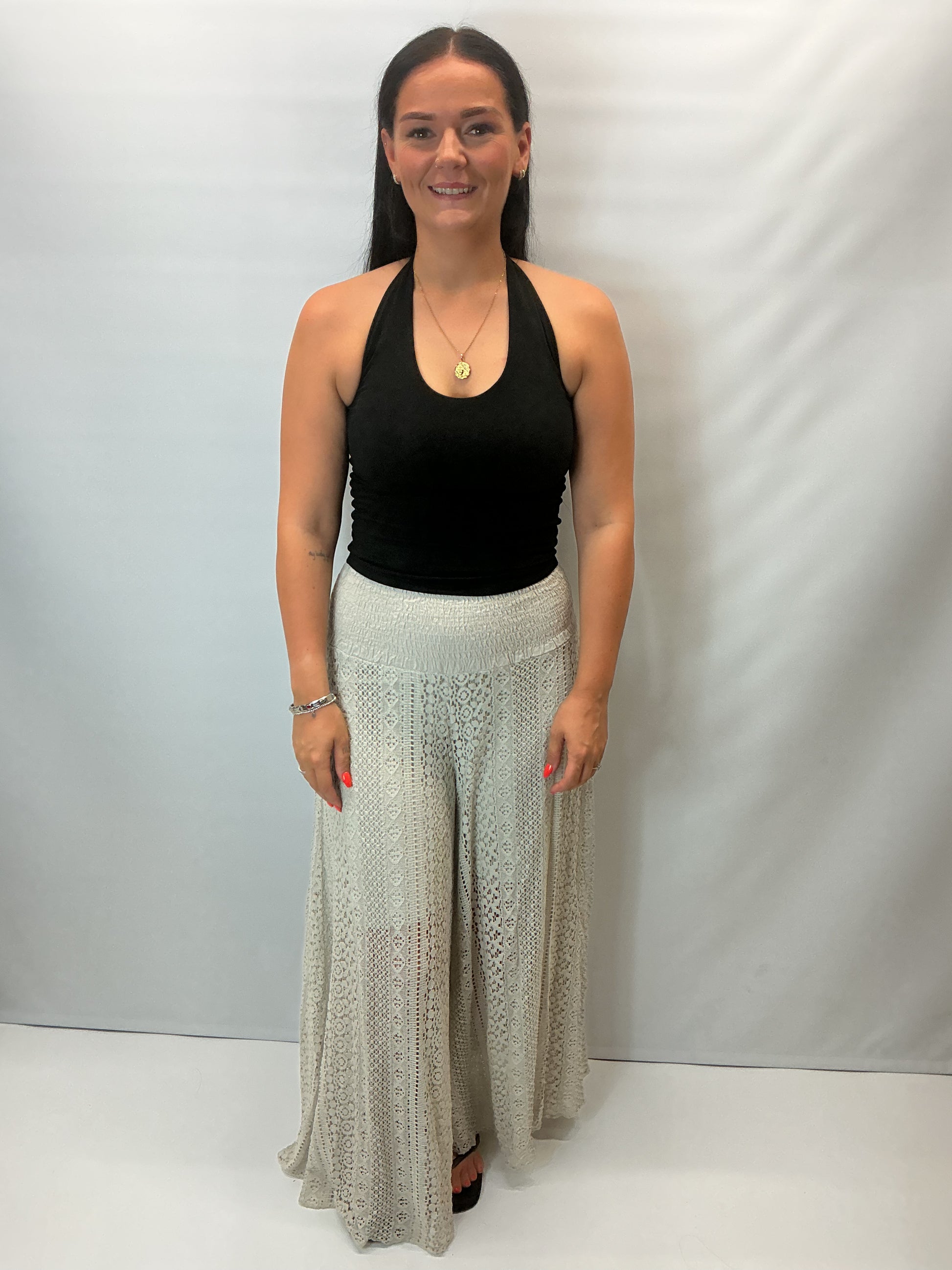 Upgrade your summer wardrobe with our lace wide leg trousers, designed for effortless style and all-day comfort. Featuring a high-waisted smocked waistband and a flowing wide-leg silhouette, these trousers create a flattering, elongating fit perfect for warm-weather dressing.