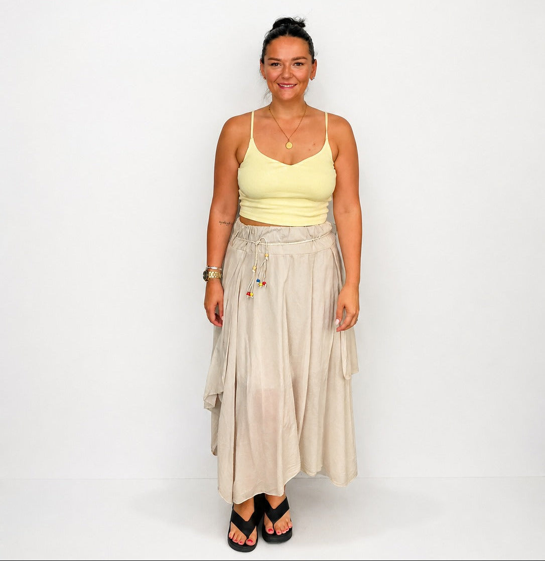 Ladies Italian boho maxi skirt in beige with an asymmetric hem, elasticated drawstring waistband and flowing relaxed fit.