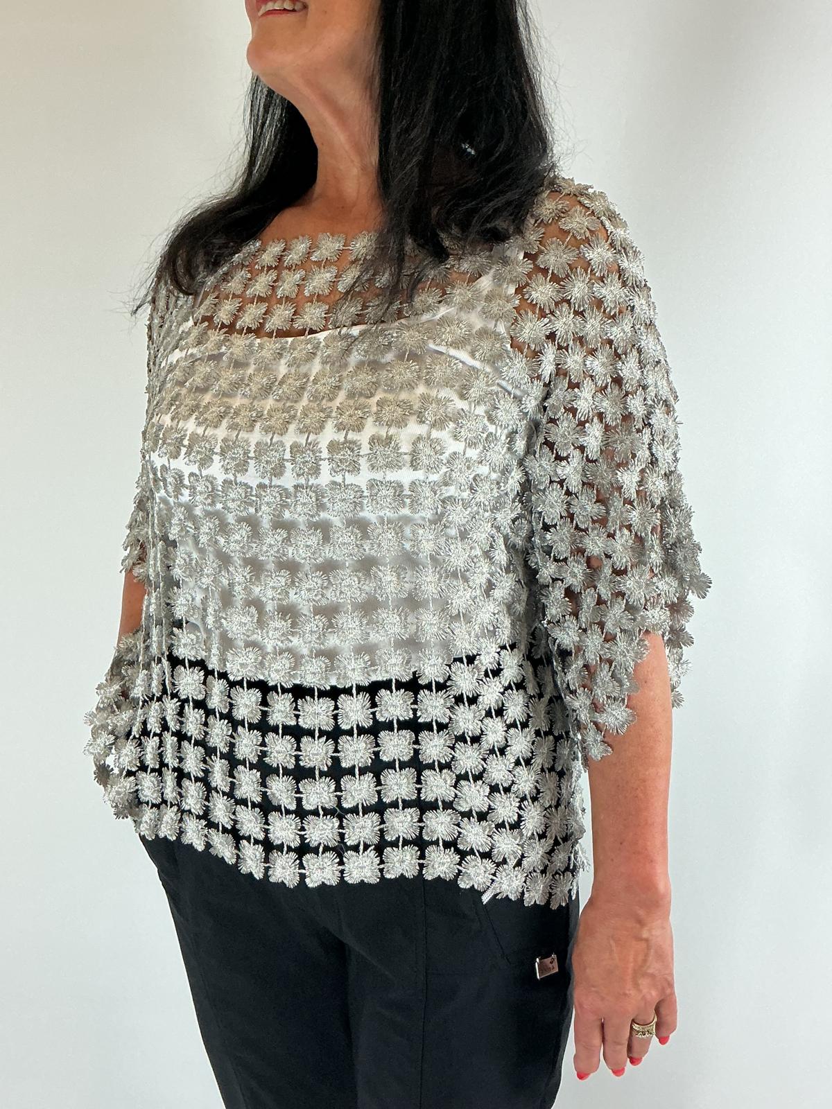 Ladies grey semi-sheer floral embroidered top with short sleeves, a relaxed fit and scalloped edges