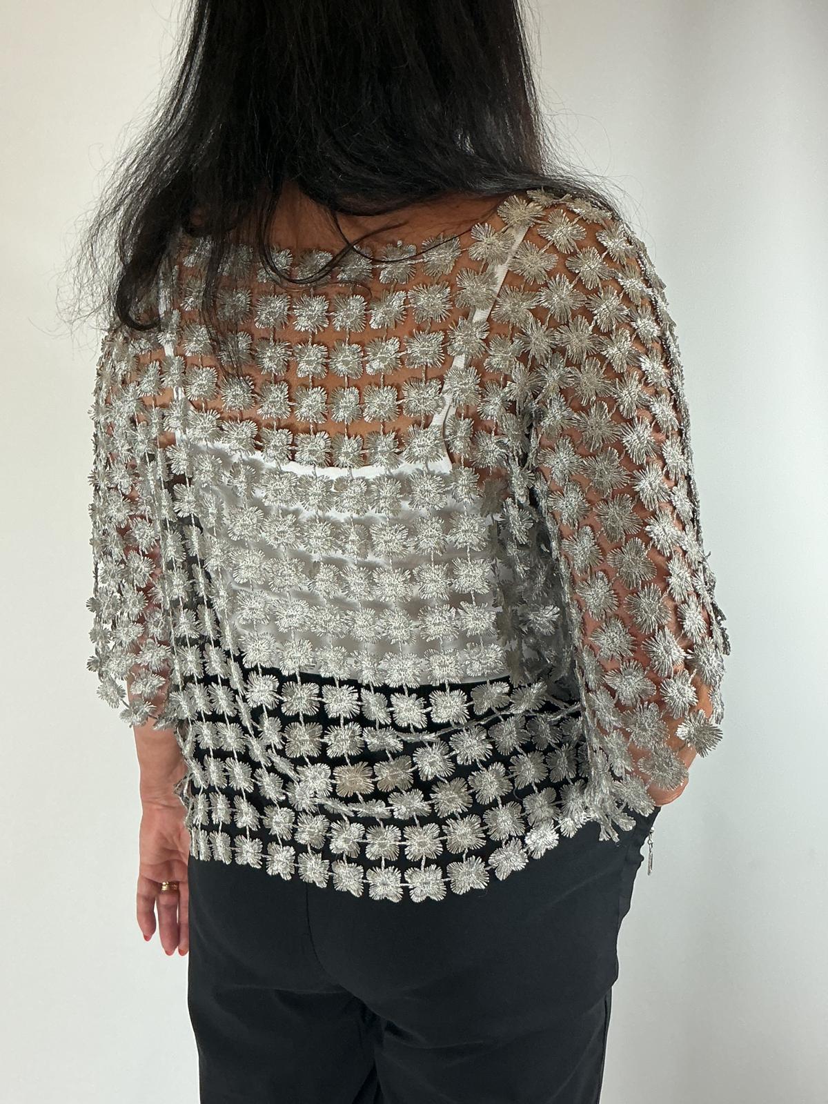 Ladies grey semi-sheer floral embroidered top with short sleeves, a relaxed fit and scalloped edges