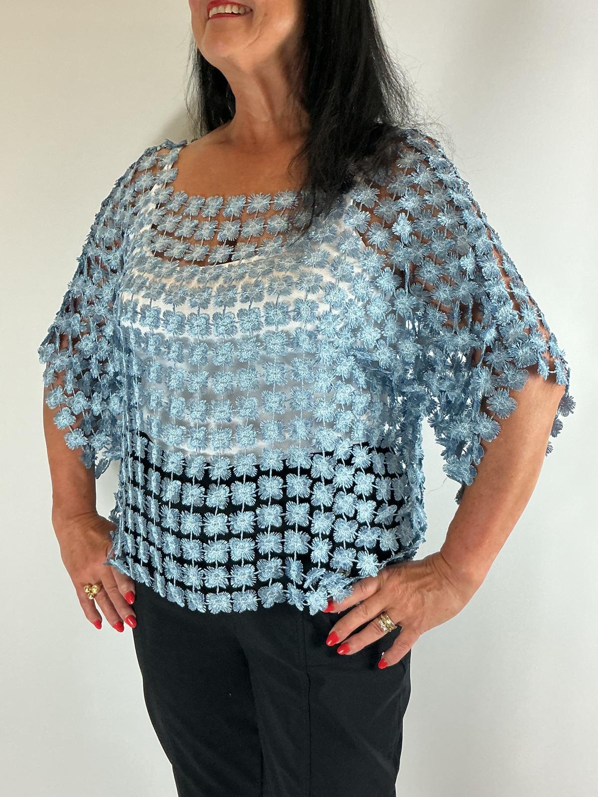 Ladies light blue semi-sheer floral embroidered top with short sleeves, a relaxed fit and scalloped edges