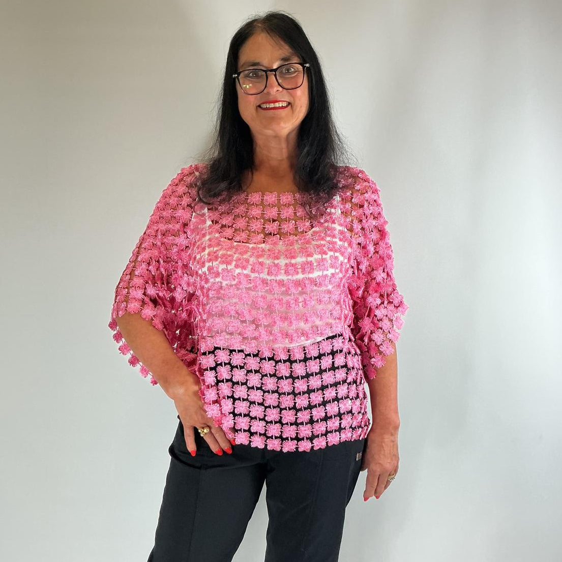 Ladies pink semi-sheer floral embroidered top with short sleeves, a relaxed fit and scalloped edges