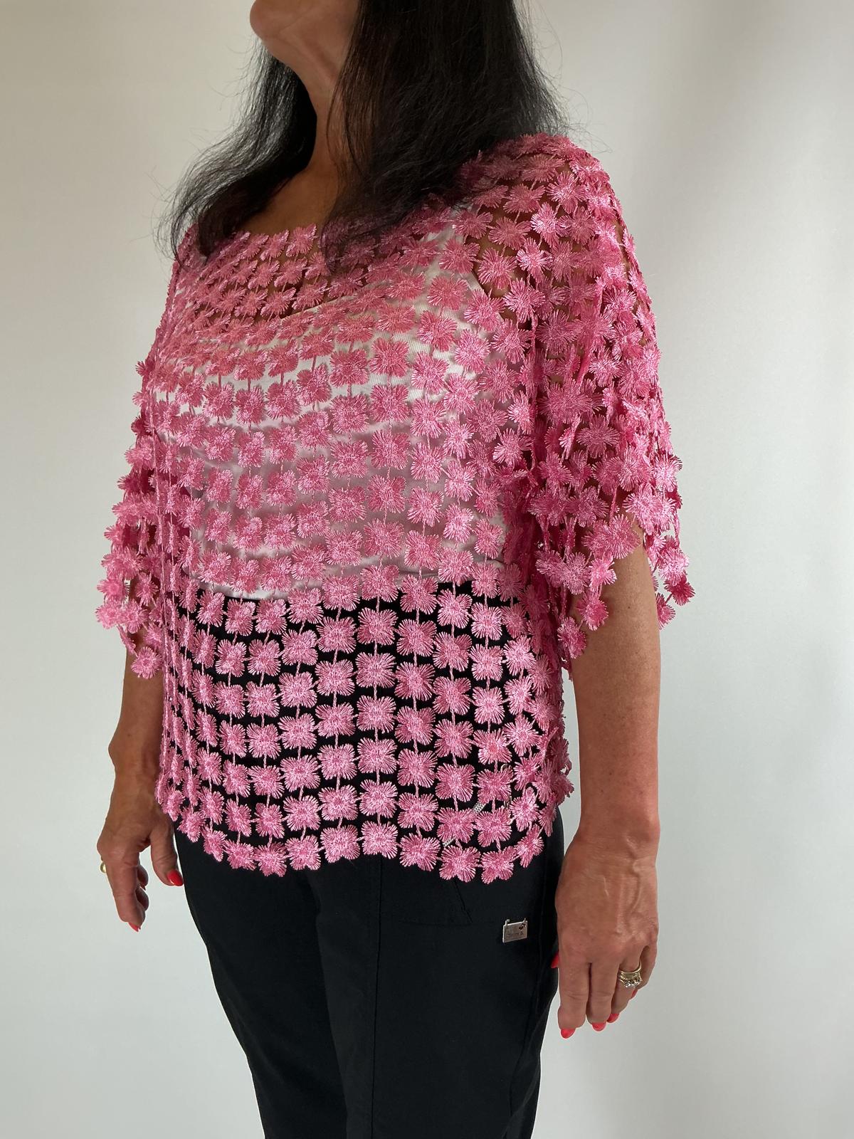 Ladies pink semi-sheer floral embroidered top with short sleeves, a relaxed fit and scalloped edges