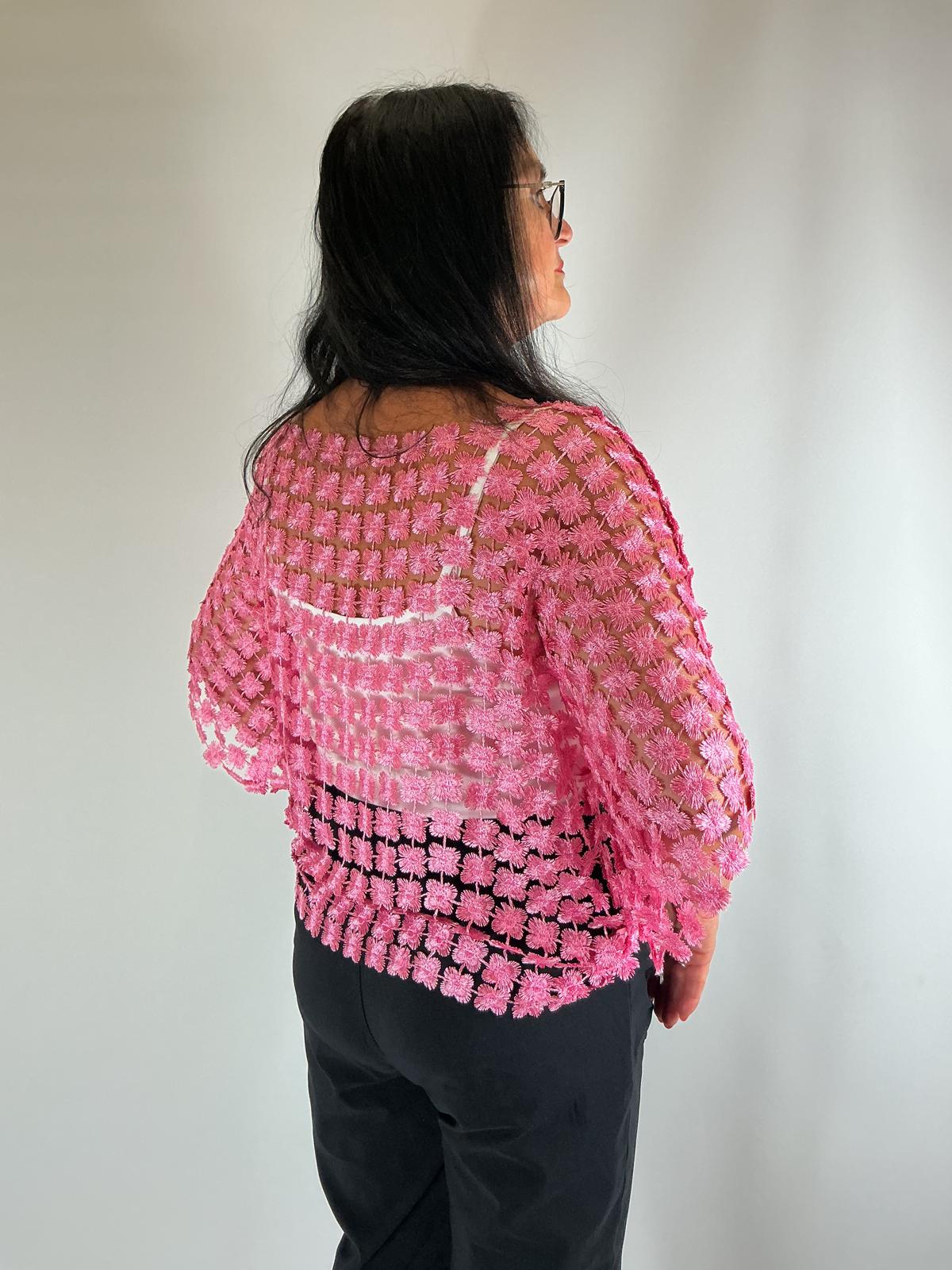 Ladies pink semi-sheer floral embroidered top with short sleeves, a relaxed fit and scalloped edges