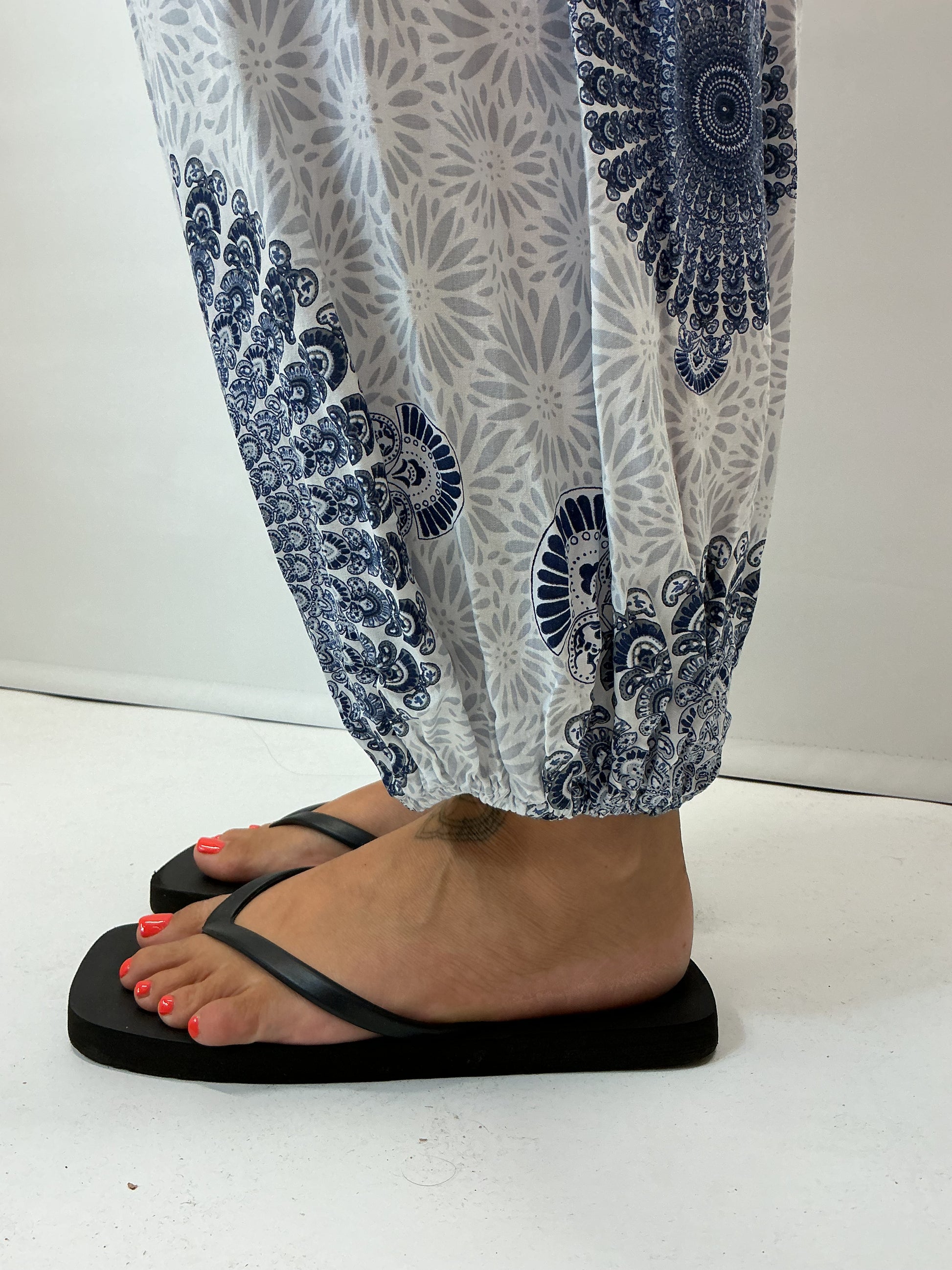 Women's Italian white mandala print harem trousers with stretch waistband, relaxed balloon leg fit and elasticated cuffs.