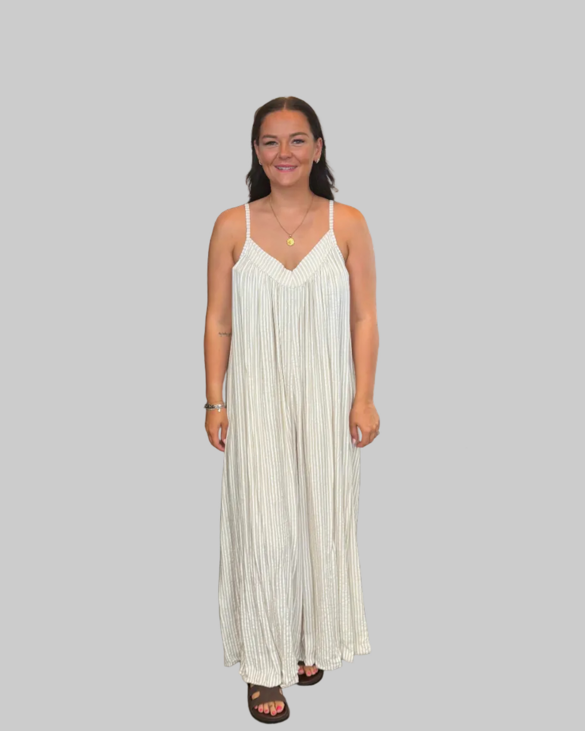 Women's blue and white striped wide leg jumpsuit with adjustable straps, modelled with a relaxed fit