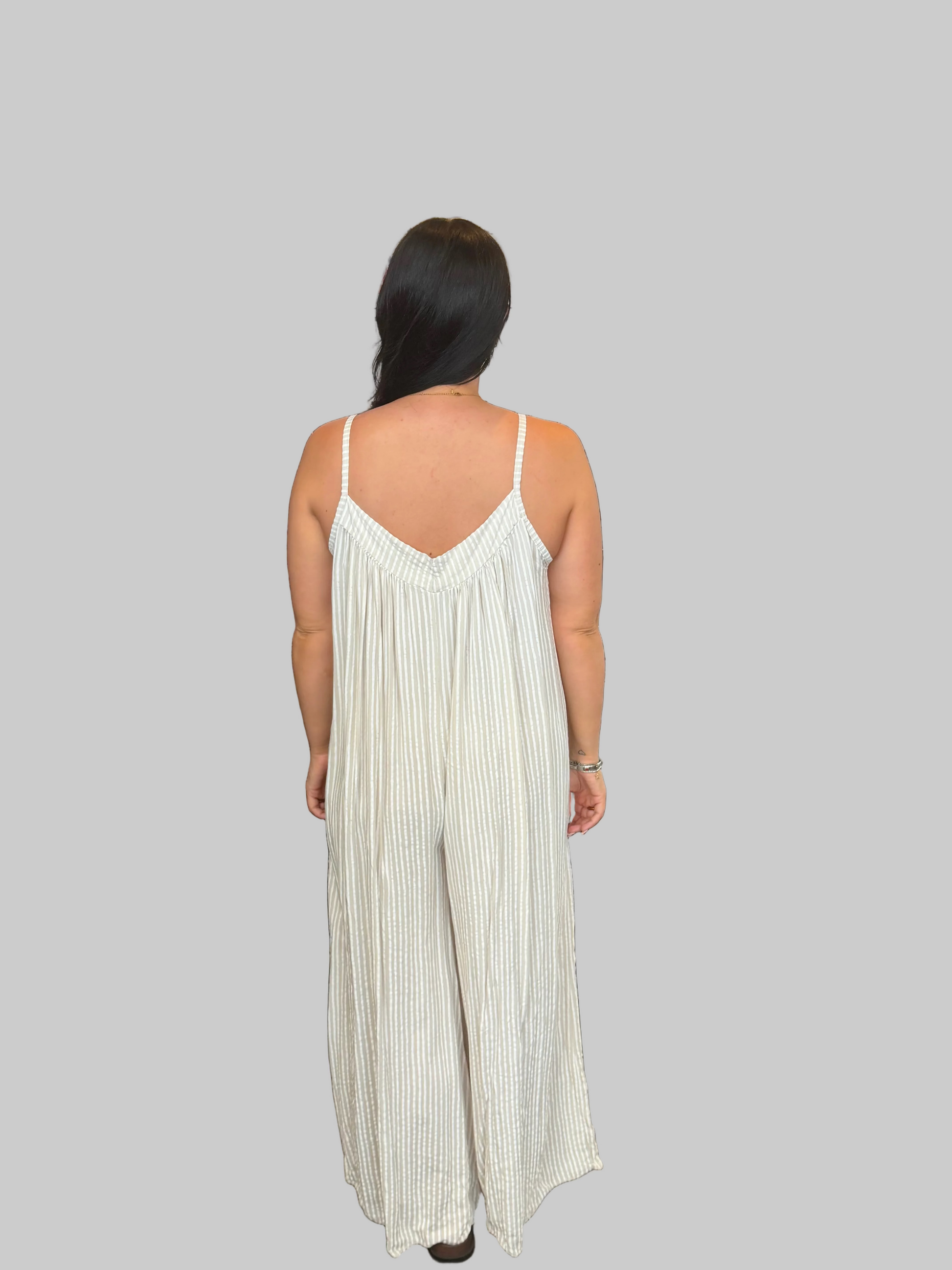 Women's blue and white striped wide leg jumpsuit with adjustable straps, modelled with a relaxed fit