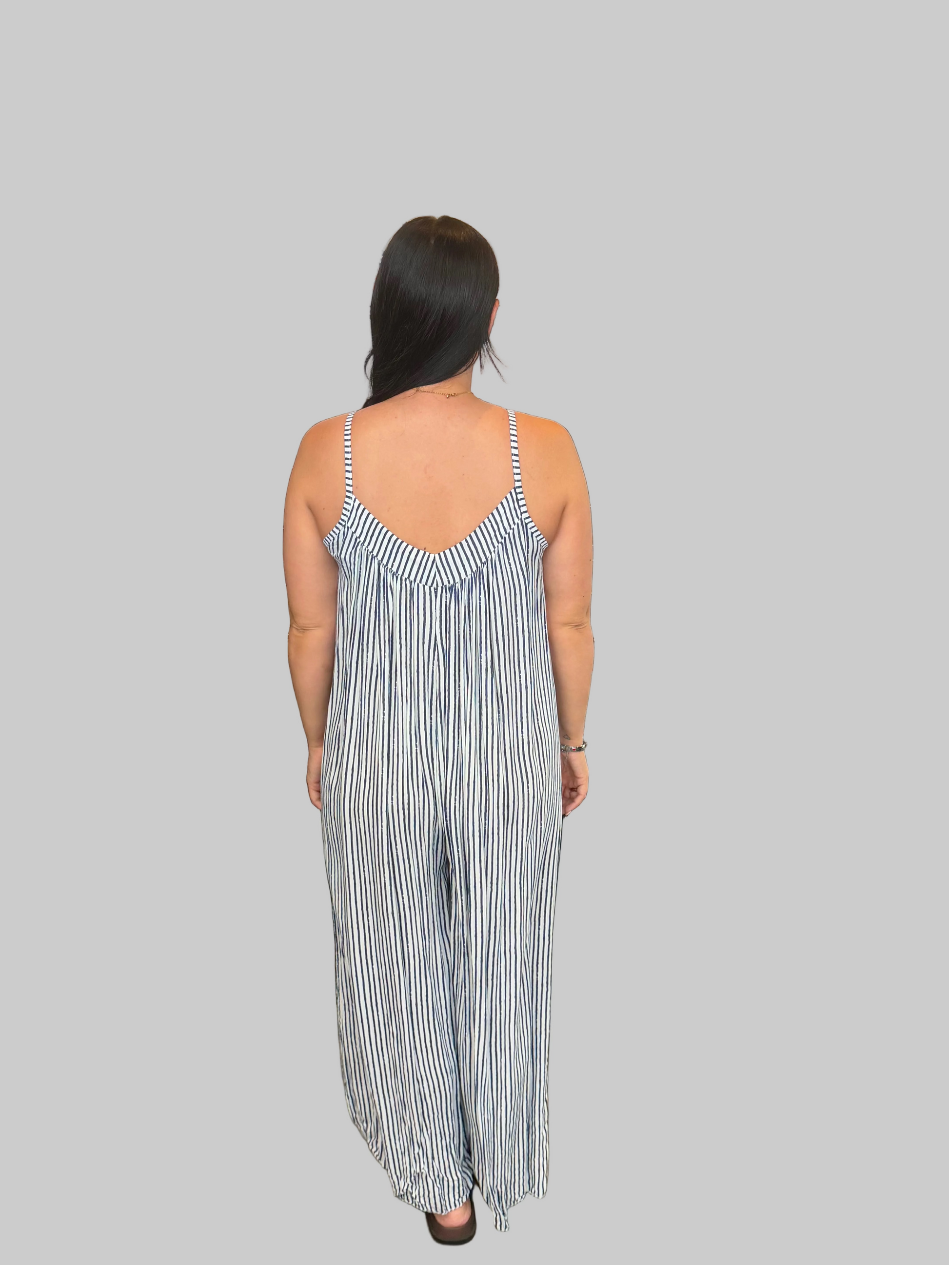Women's Navy and white striped wide leg jumpsuit with adjustable straps, modelled with a relaxed fit.