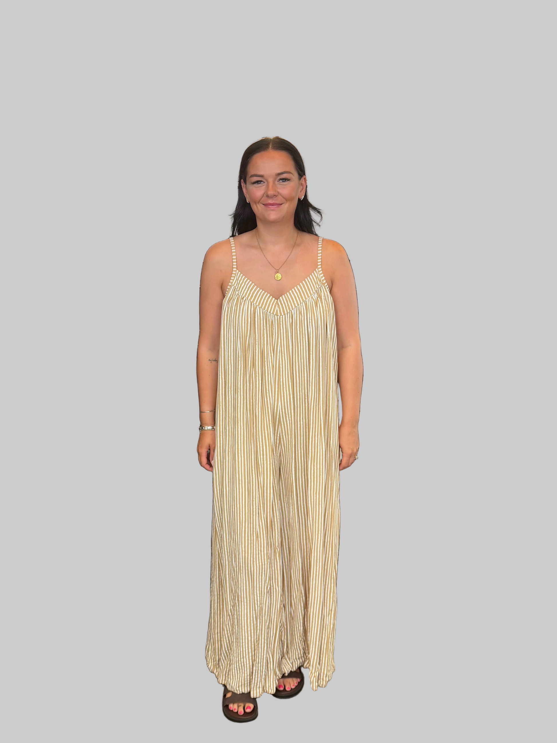 Women's Yellow and white striped wide leg jumpsuit with adjustable straps, modelled with a relaxed fit.