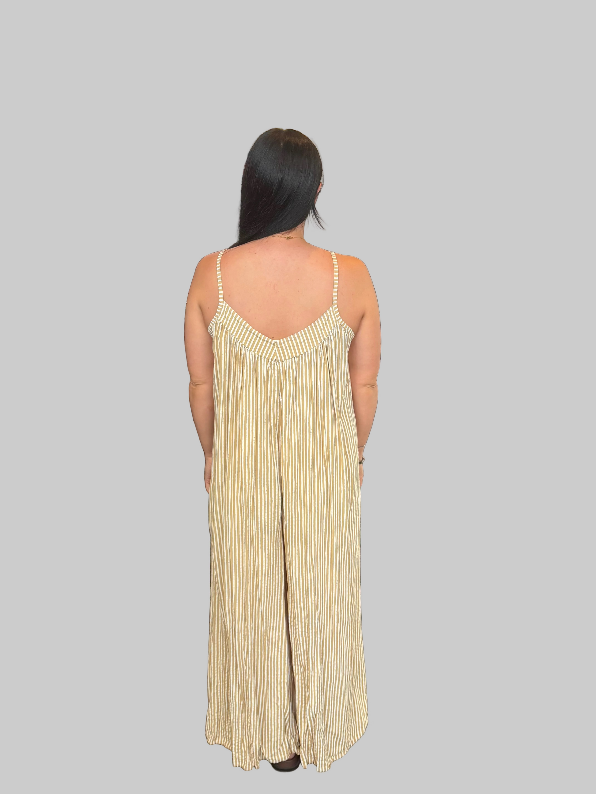 Women's Yellow and white striped wide leg jumpsuit with adjustable straps, modelled with a relaxed fit