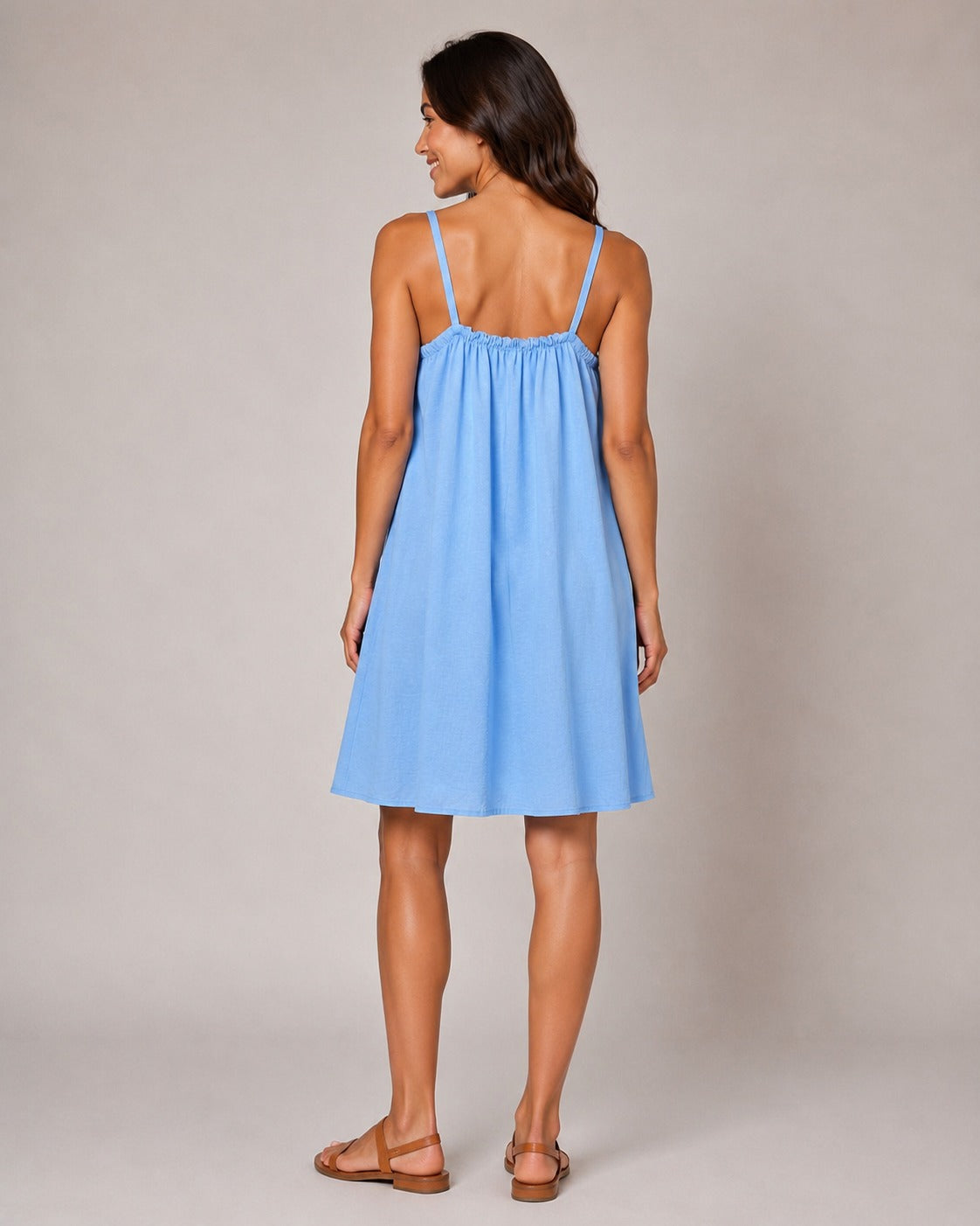 Light Blue swing dress with a gathered neckline, thin shoulder straps and a relaxed knee-length silhouette.