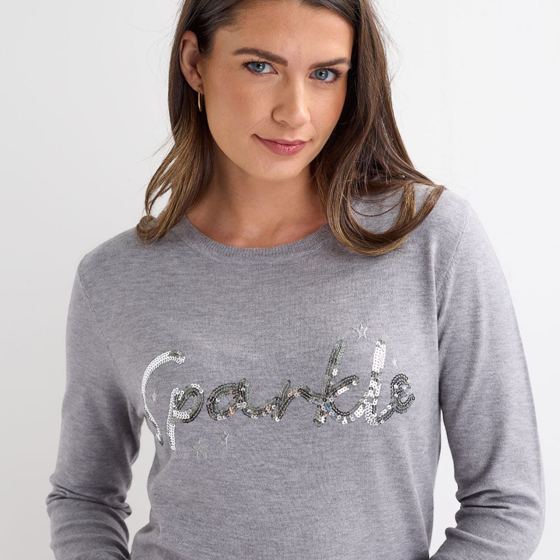 Ladies light grey jumper with silver sequin ‘sparkle’ slogan, long sleeves and a festive xmas style.