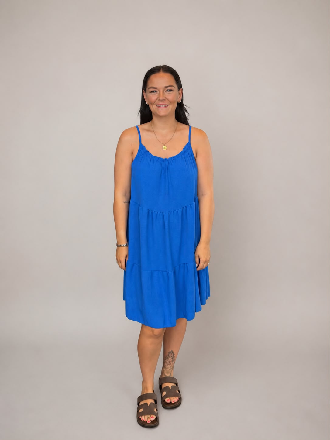 A versatile Royal Blue tiered cami dress featuring spaghetti straps, a relaxed, flowy fit, and a flattering knee-length design. Lightweight and easy to wear, it's ideal for casual everyday styling, holidays, weekends, and warm-weather occasions.