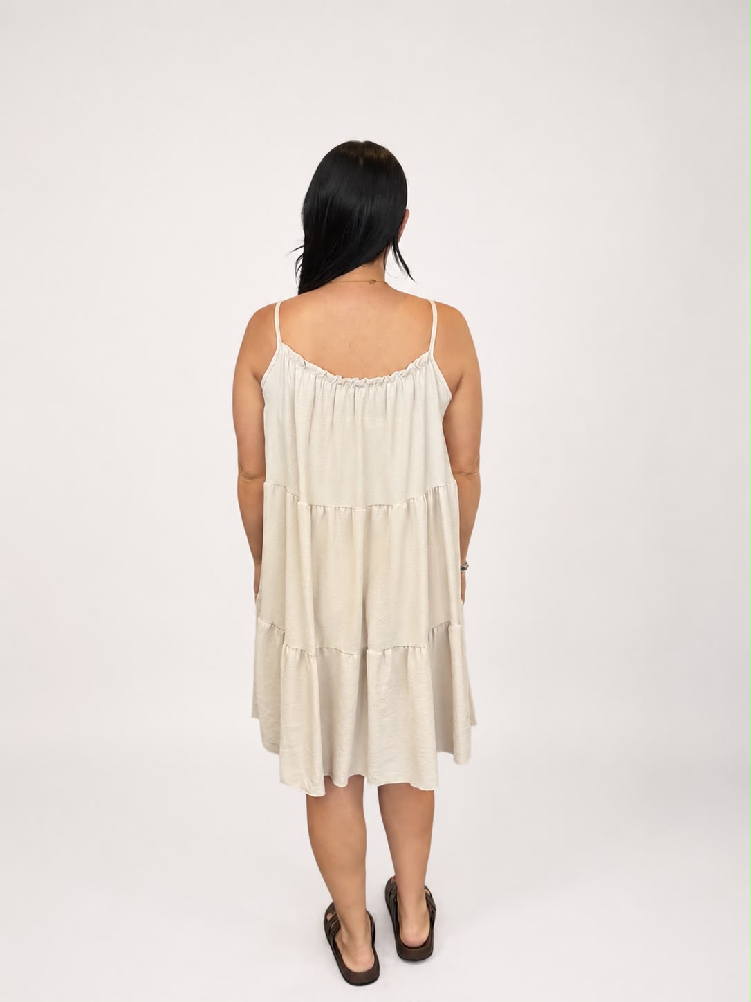 A versatile bagie tiered cami dress featuring spaghetti straps, a relaxed, flowy fit, and a flattering knee-length design. Lightweight and easy to wear, it's ideal for casual everyday styling, holidays, weekends, and warm-weather occasions.