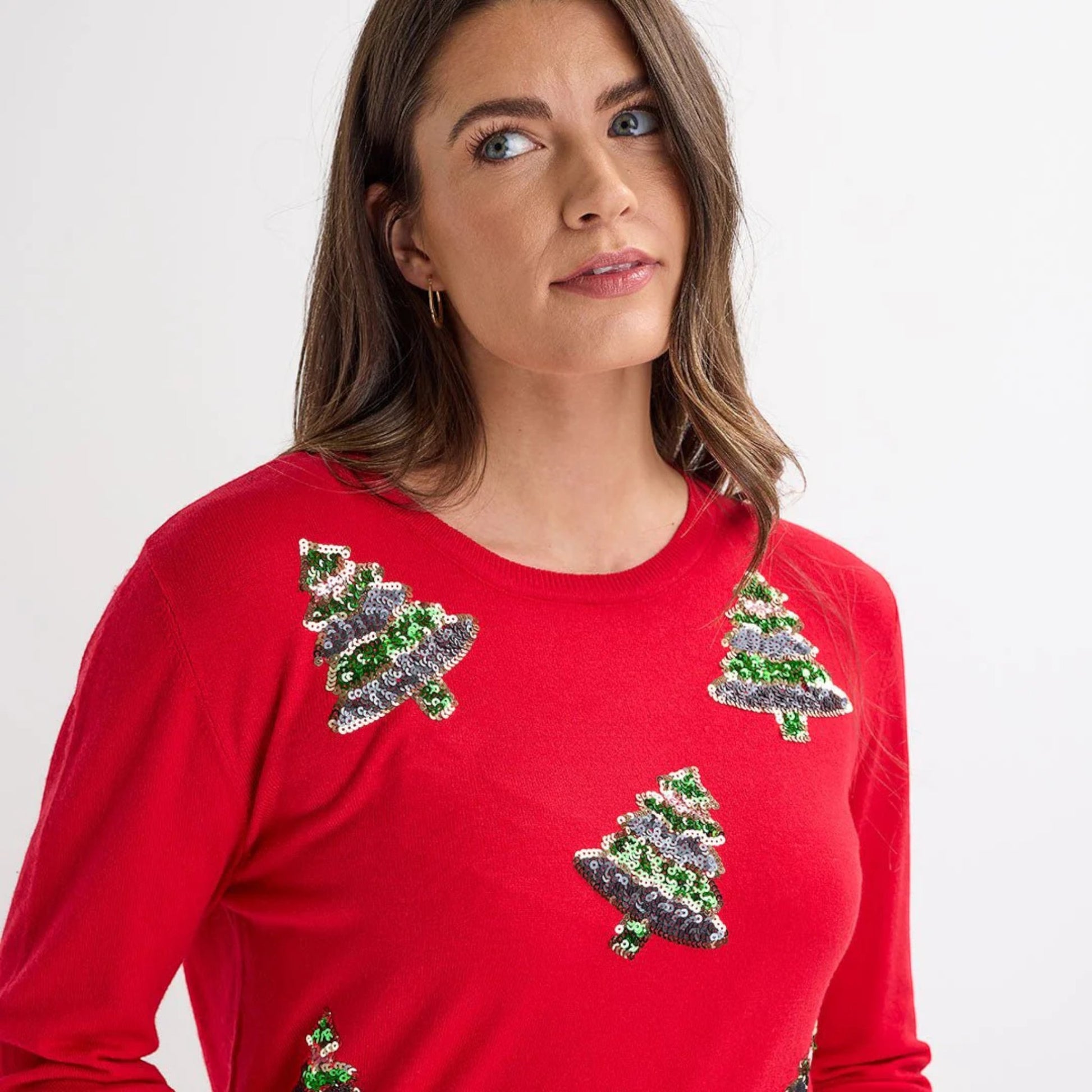 Ladies red Christmas jumper featuring multiple green sequin Christmas tree motifs, long sleeves and festive xmas design.