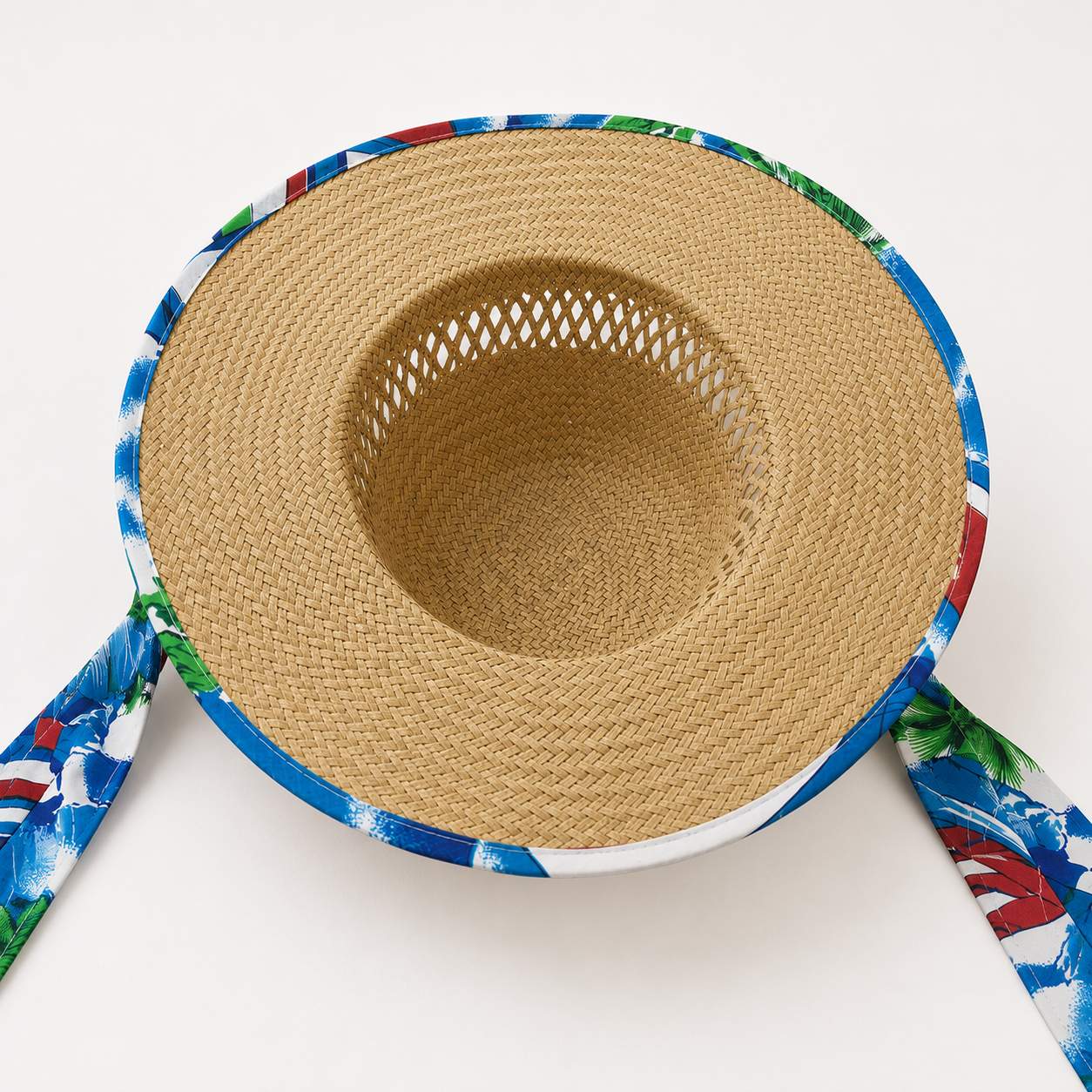 Women's tropical print wide brim sun hat featuring a blue beach-inspired design with a woven brim, perfect for summer holidays.
