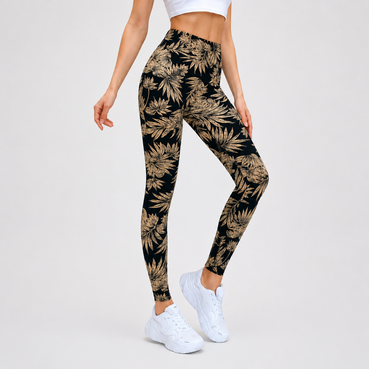 Women's black leggings with beige tropical leaf print, full-length stretch fit.