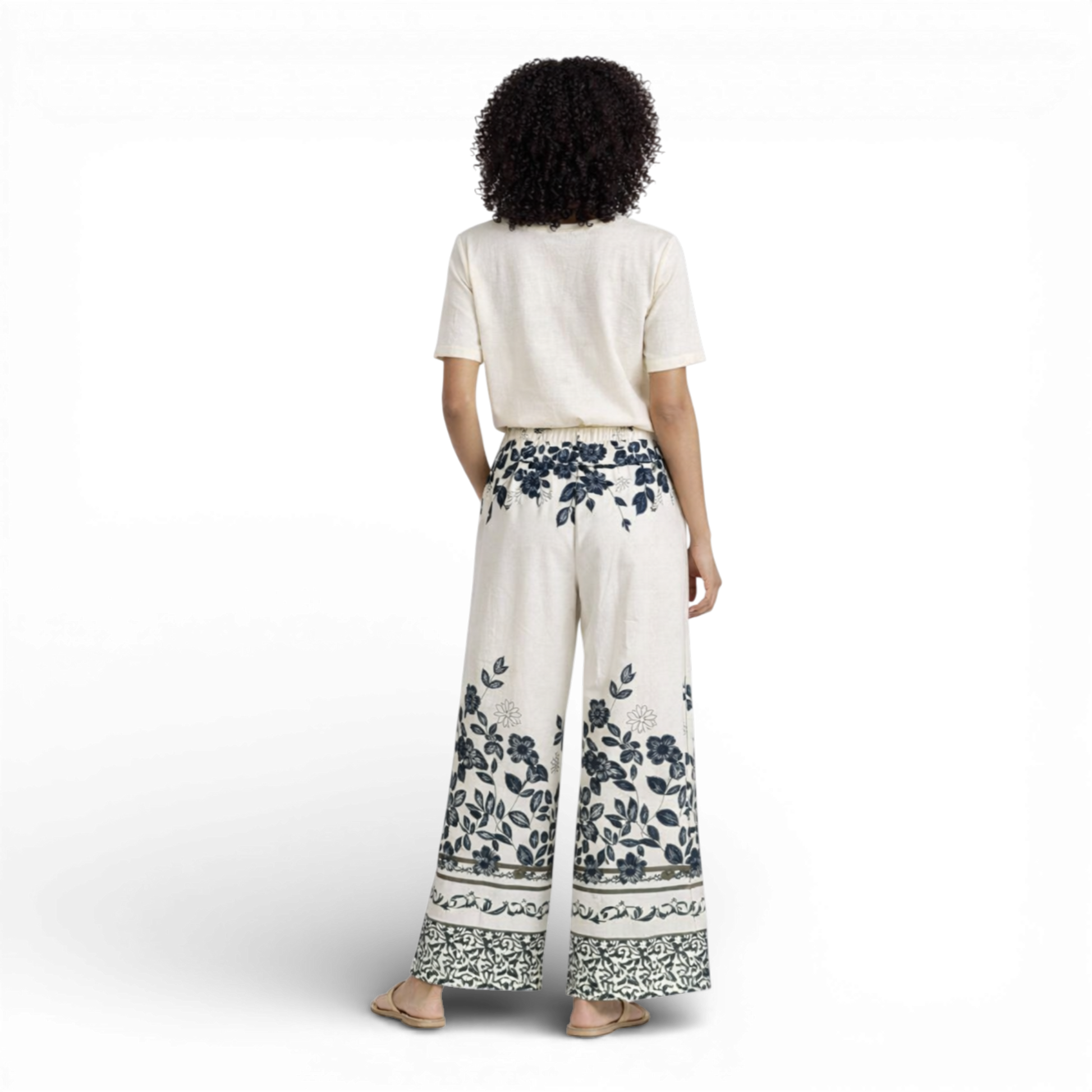 Beautiful cream wide-leg trousers featuring an elegant all-over floral print. Designed with a comfortable elasticated waistband and drawstring tie for an adjustable fit.