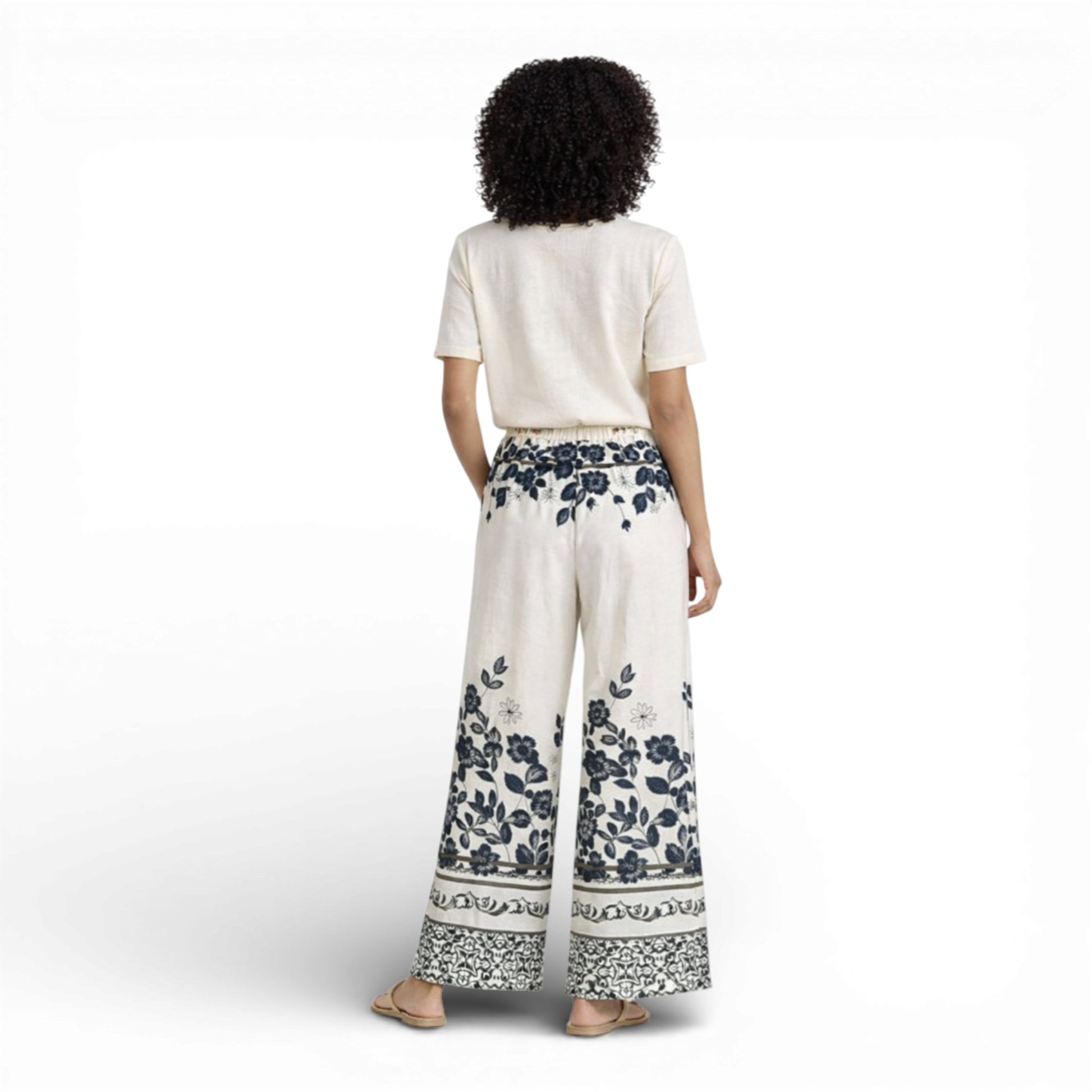 Beautiful cream wide-leg trousers featuring an elegant all-over floral print. Designed with a comfortable elasticated waistband and drawstring tie for an adjustable fit.
