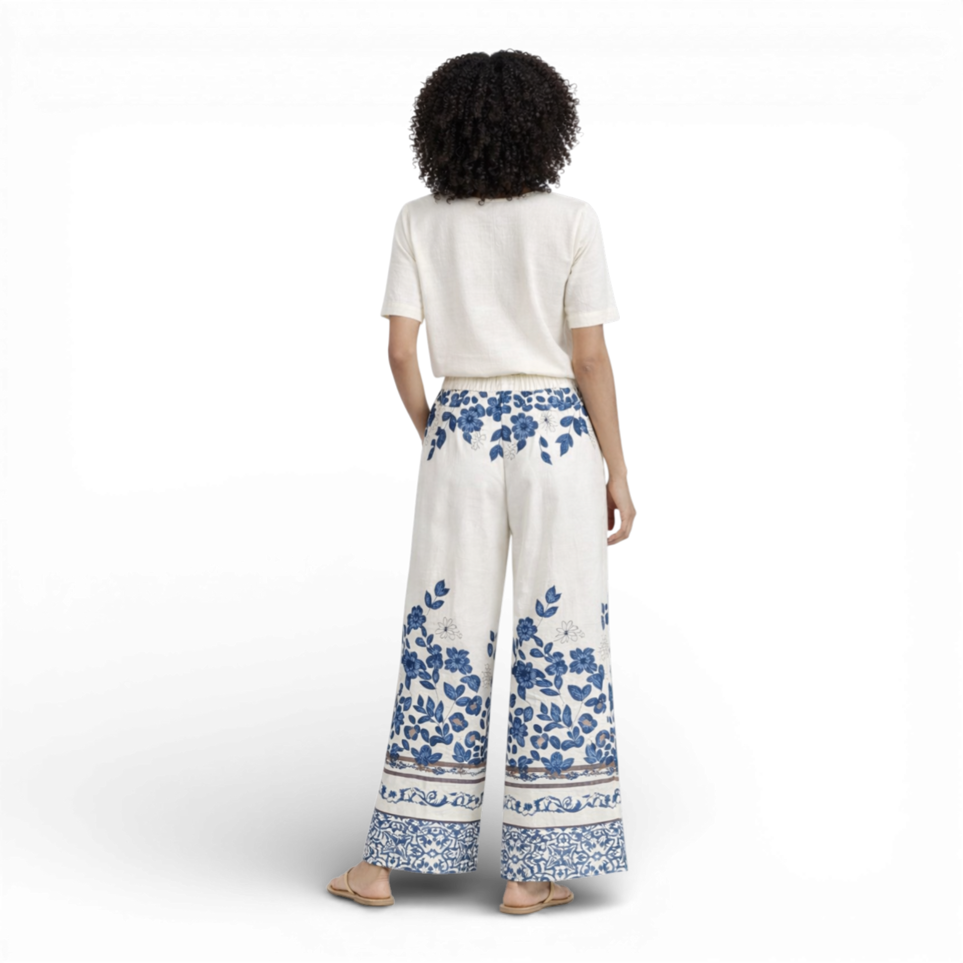 Beautiful cream wide-leg trousers featuring an elegant all-over floral print. Designed with a comfortable elasticated waistband and drawstring tie for an adjustable fit.