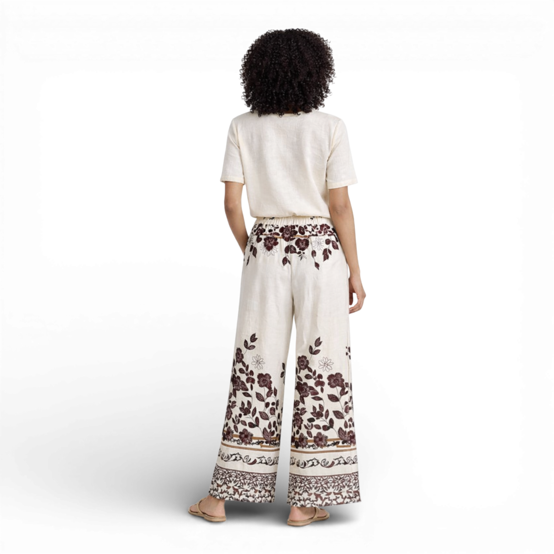Beautiful cream wide-leg trousers featuring an elegant all-over floral print. Designed with a comfortable elasticated waistband and drawstring tie for an adjustable fit.