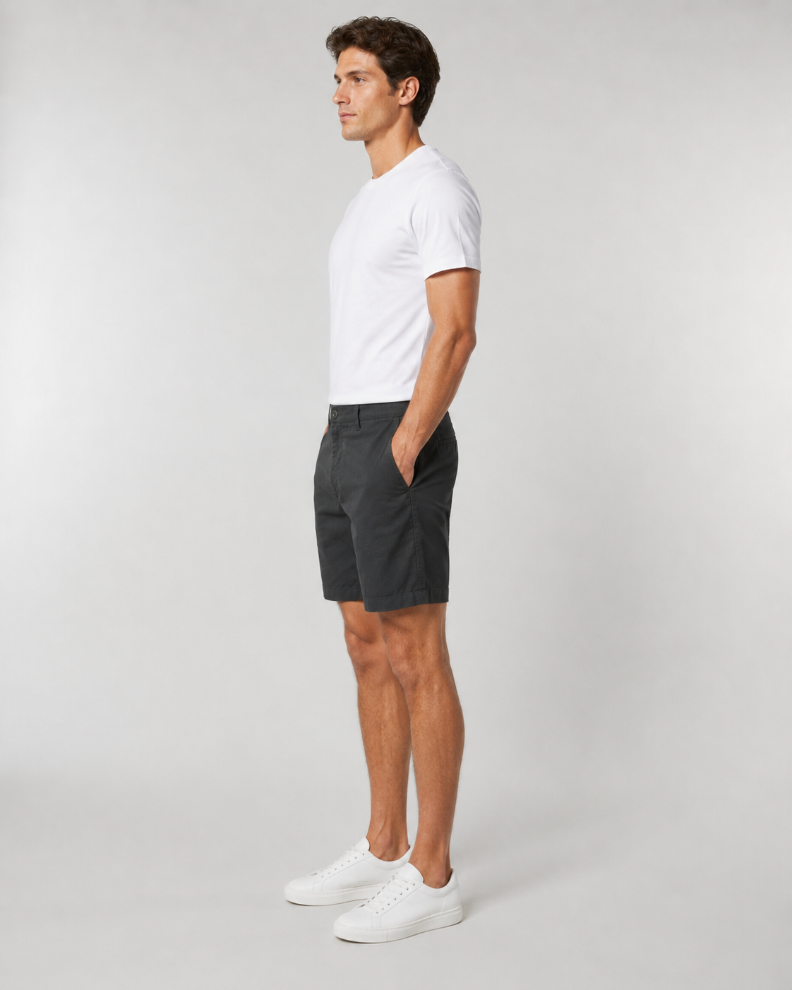 Men's black chino shorts paired with white t-shirt and white sneakers