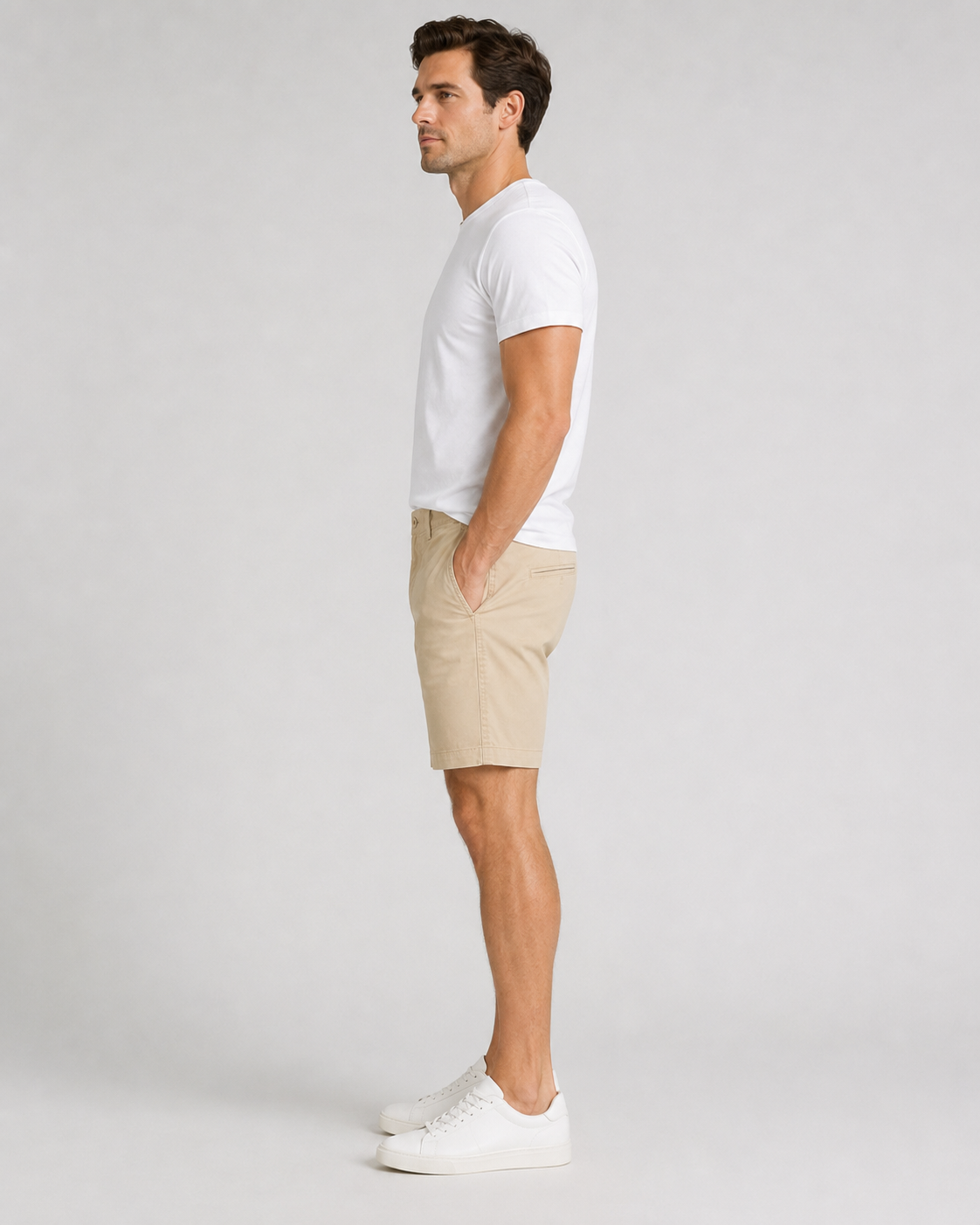 Men's beige chino shorts with white crew neck t-shirt and white sneakers